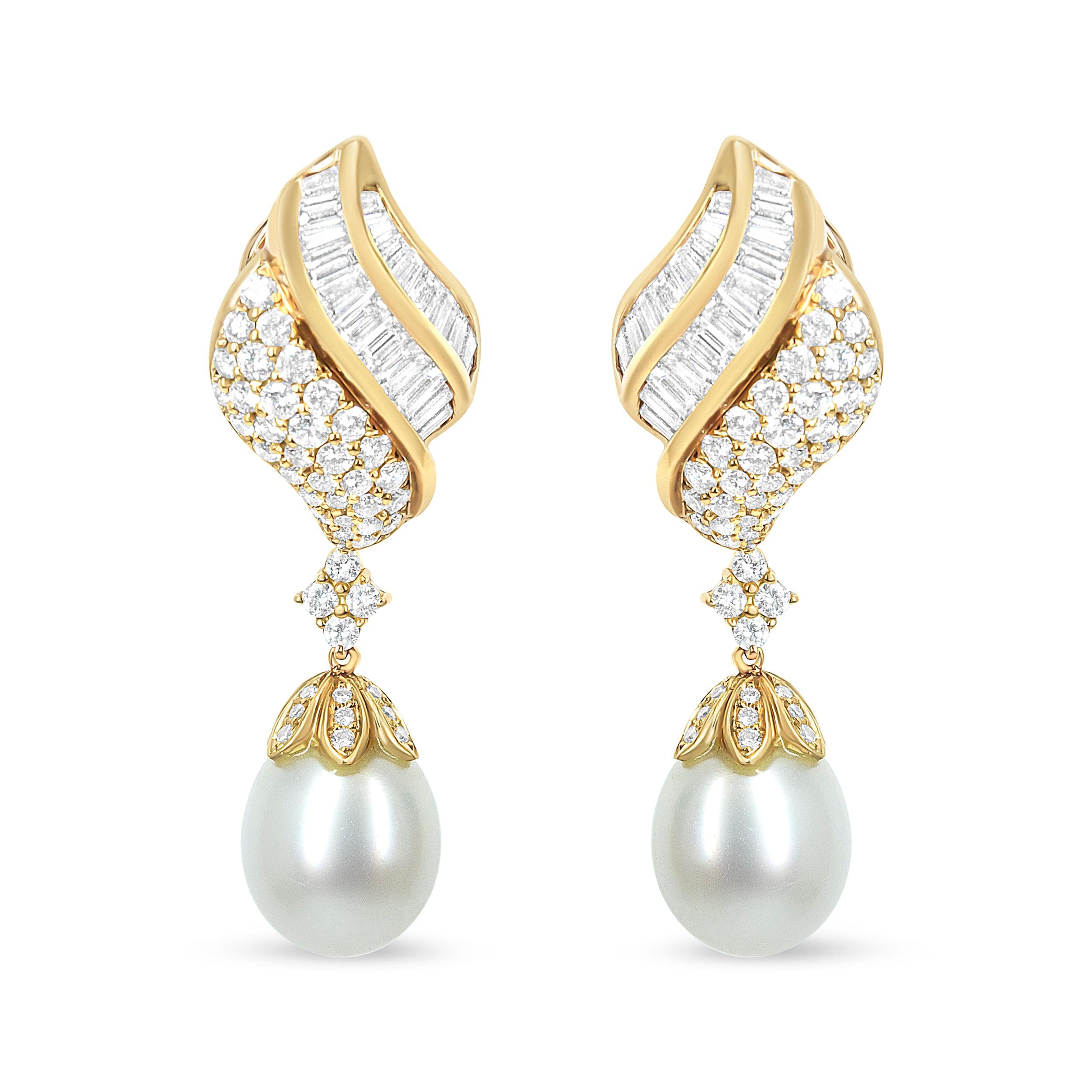 Delicate details indulge this spectacular pair of diamond South Sea pearl drop dangle earrings in splendid form. Crafted in fine 18k yellow gold, each earring features a lustrous 12.5-13.0mm South Sea cultured pearl set below an impressive array of