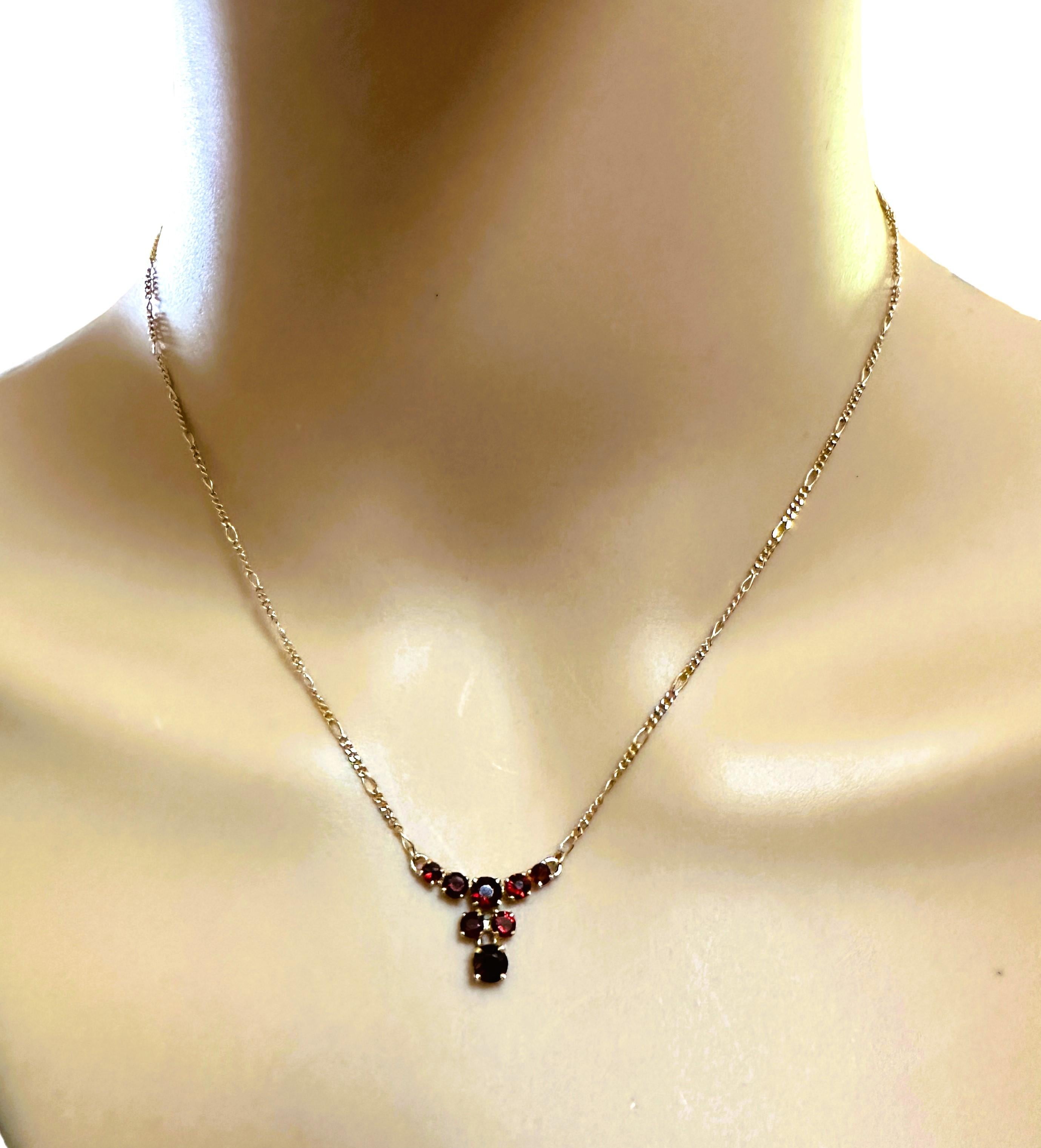 This is a gorgeous and delicate necklace!  It is pre-owned but in fabulous condition.  It has 8 beautiful Garnet stones forming a 