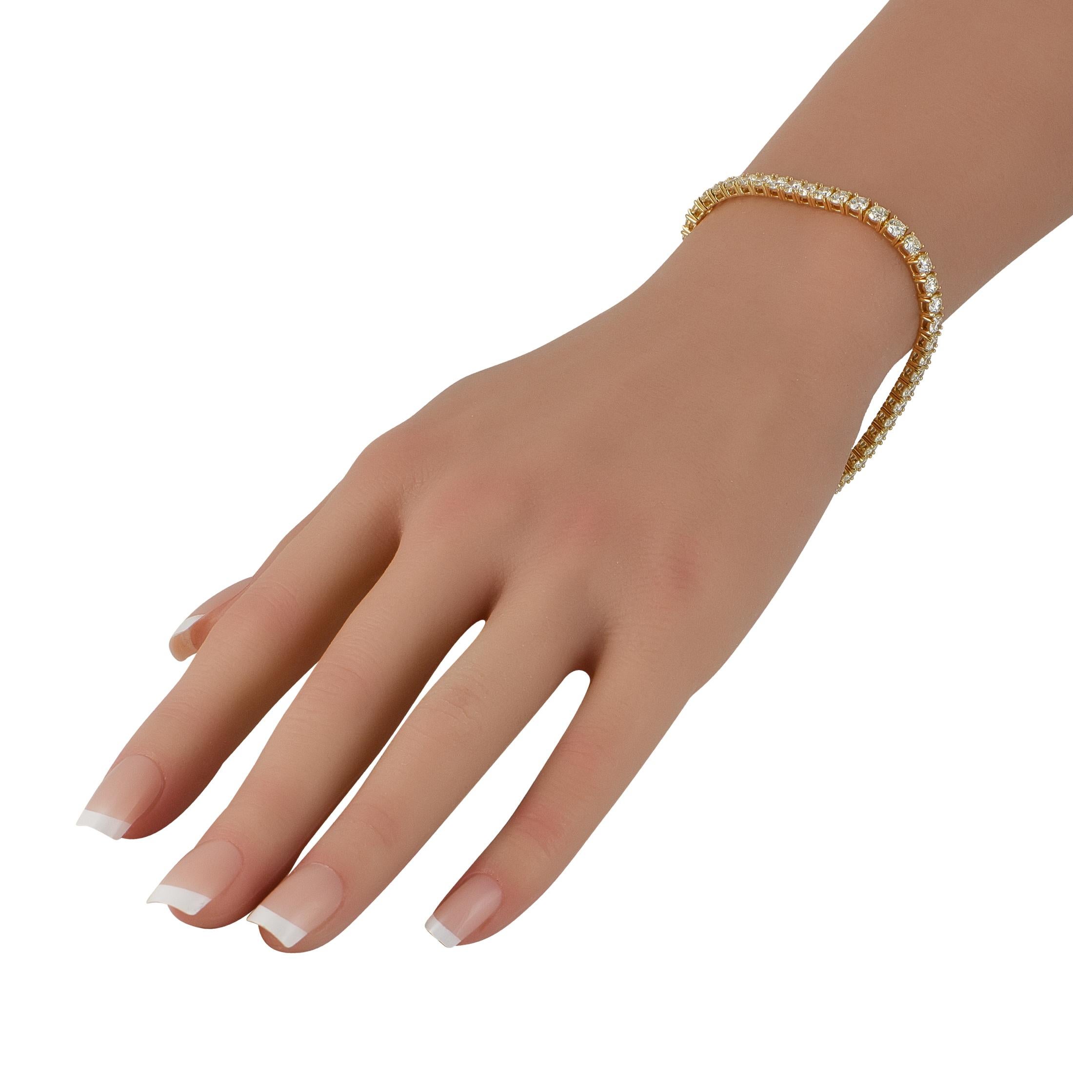 This opulent tennis bracelet will never go out of style. Diamonds with a total weight of 9.08 carats shine brightly from their place within the 18K Yellow Gold setting. Sophisticated, stunning, and ideal for any occasion, it measures 7.5 long and