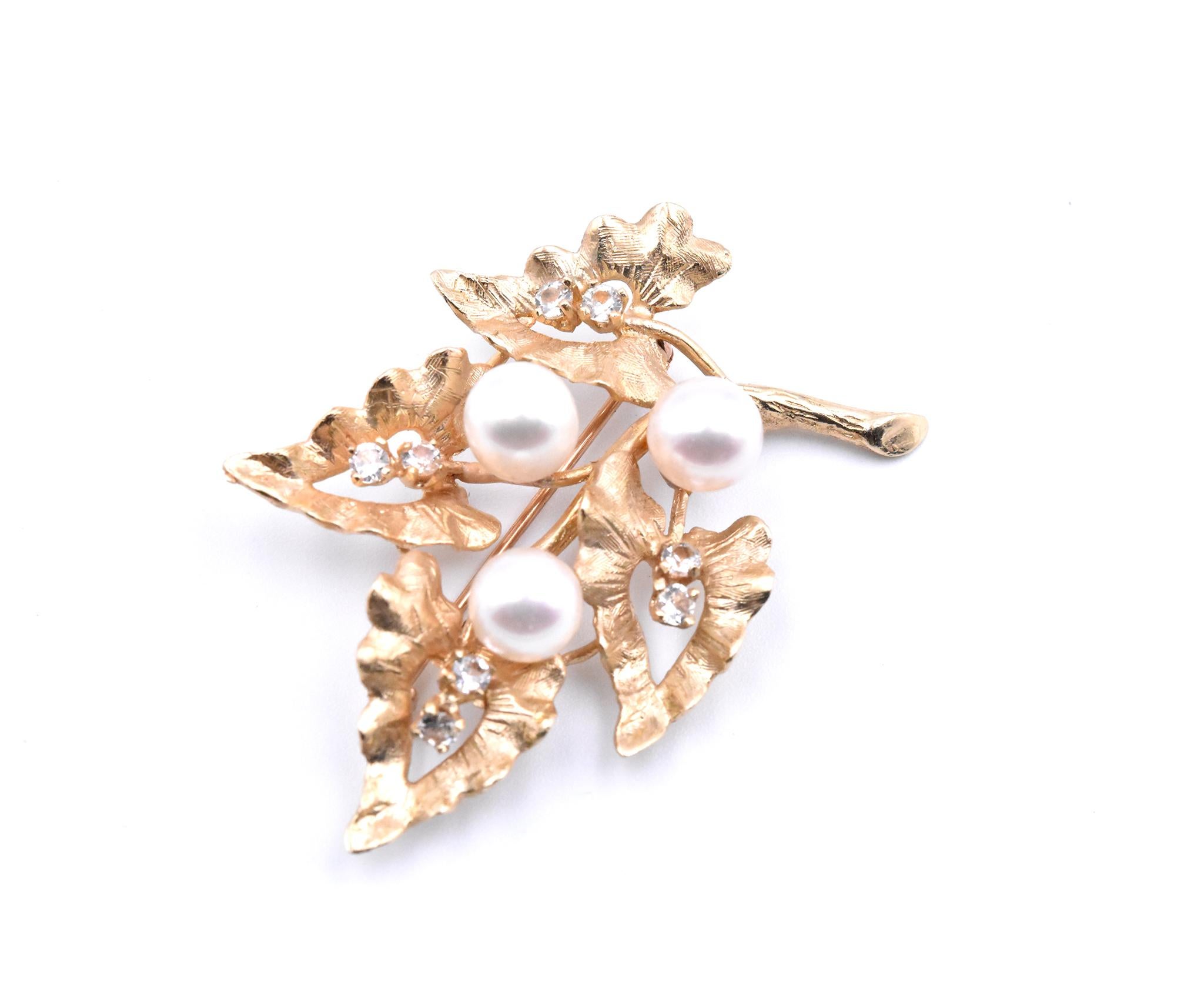 Designer: custom design
Material: 18k yellow gold
Pearl: 6.60mm akoya cultured pearls with slight rose tone
White Sapphires: 8 round white sapphires
Dimensions: pin measures 44.90mm x 30.40mm
Weight: 8.58 grams
