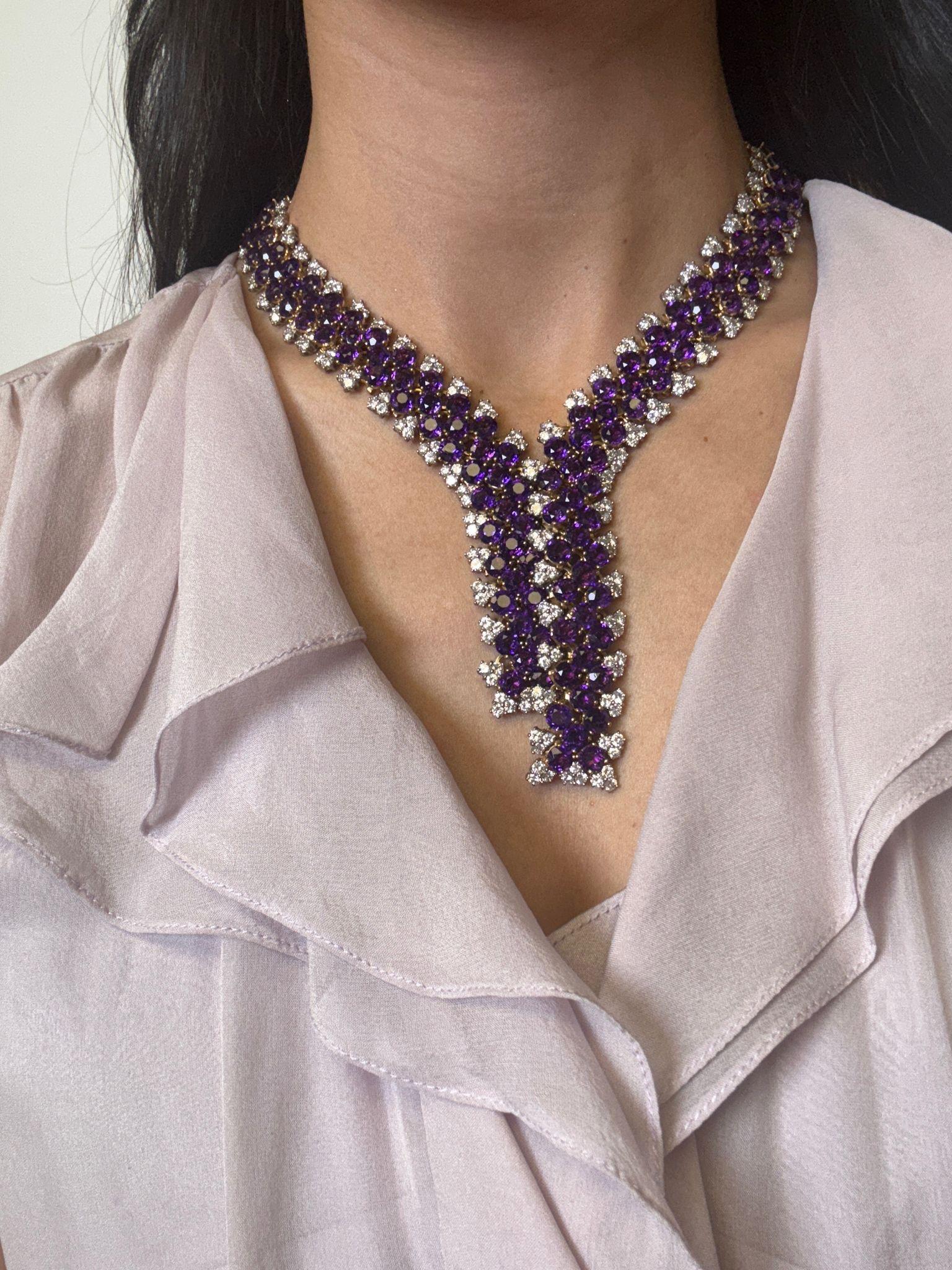 A breathtaking collar-style necklace crafted in 18k yellow gold, featuring an extraordinary 126.95 carats of richly saturated round-cut amethysts. Accenting the regal purple stones are 34.81 carats of dazzling white diamonds, arranged in a