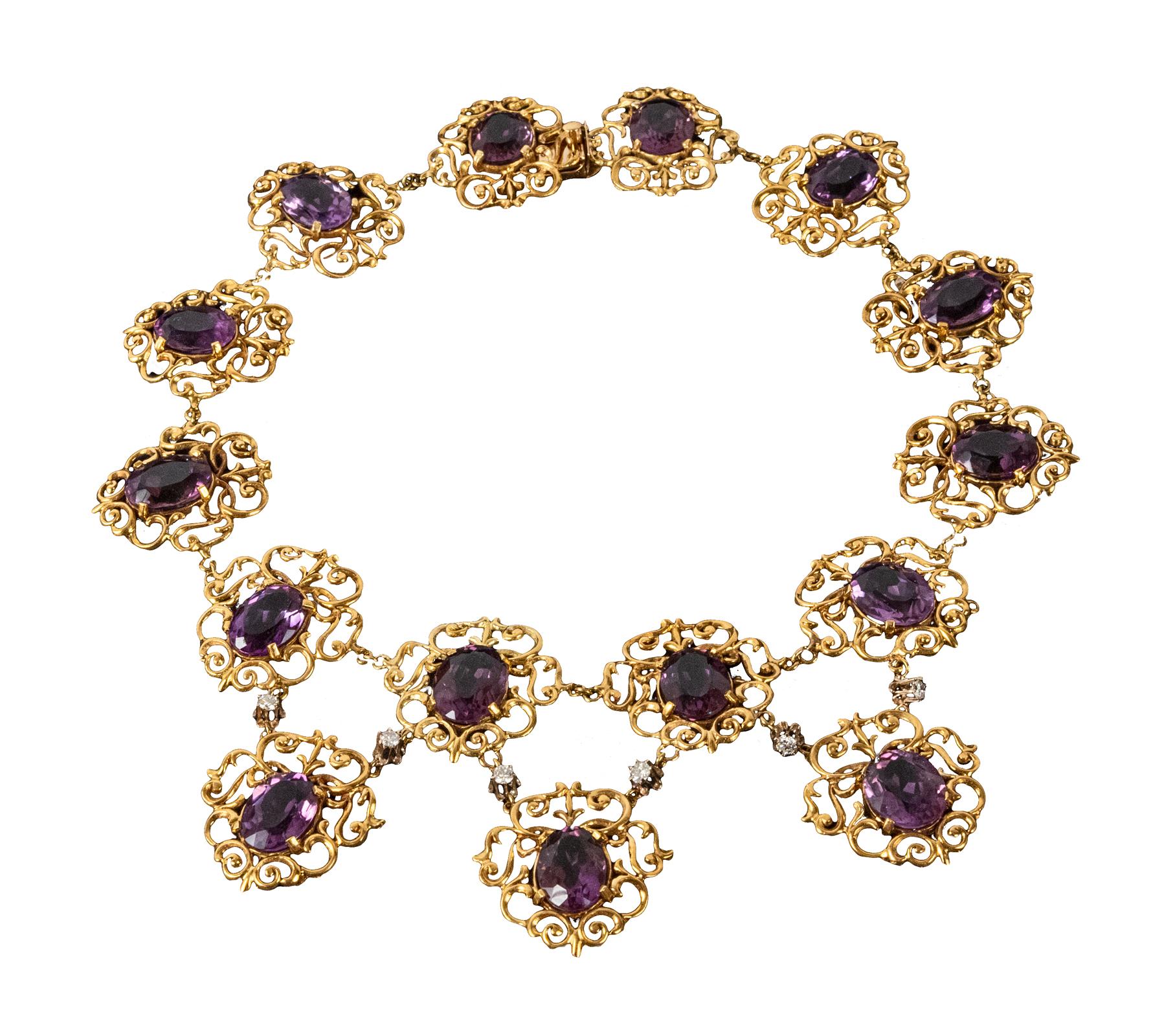 Ladies 18 karat yellow gold, amethyst and diamond necklace. Comprised of fifteen beautifully-matched large oval faceted amethysts set in filigree cartouches, three of which are suspended by links set with diamonds.