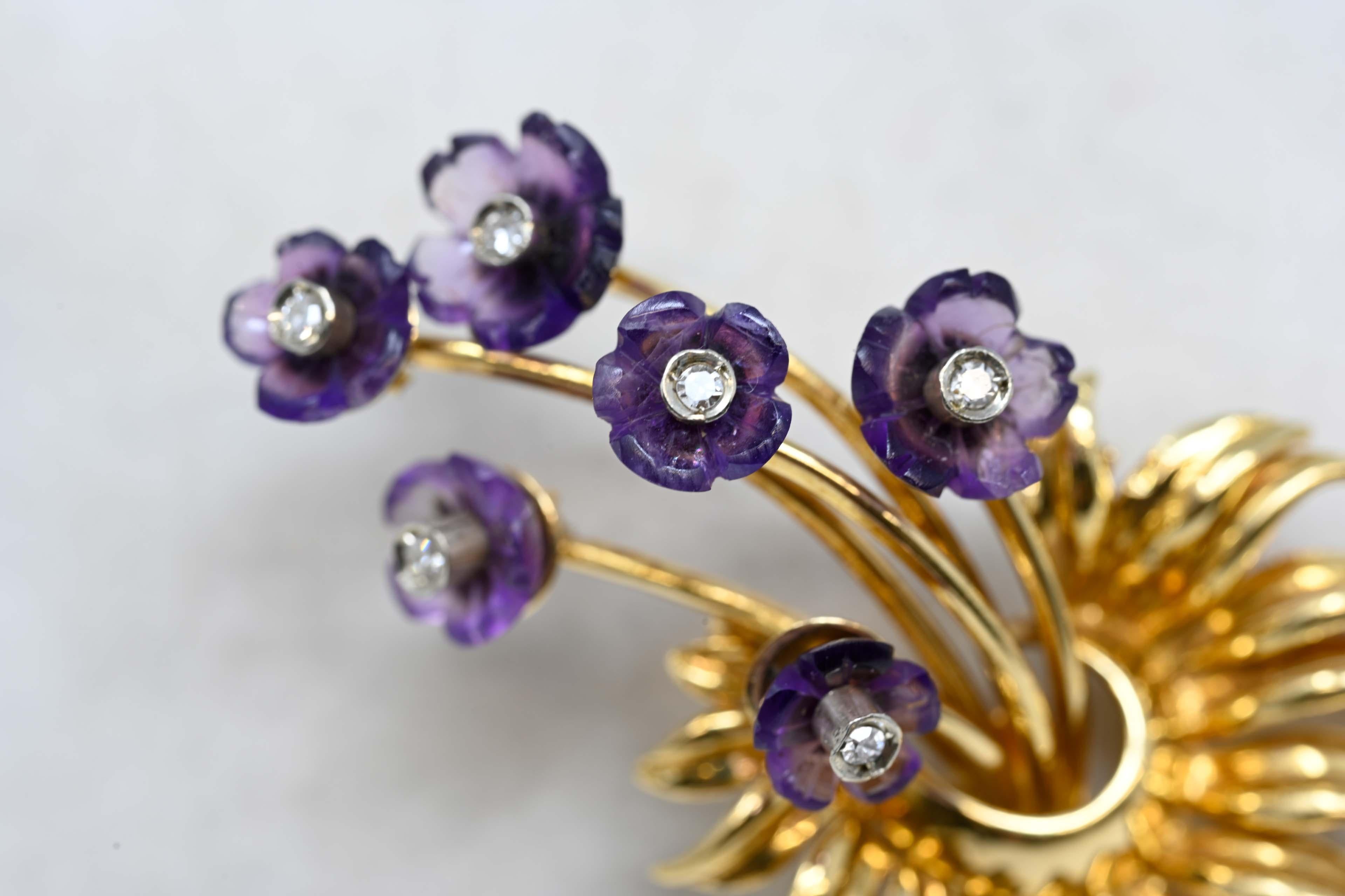 Amethyst and diamond brooch pin designed in 18k yellow gold. Carved amethyst flower with diamonds in the center, each weighing .05ct. The brooch measures 2 inches x 1 1/4 inches and marked on the back. The maker mark is AP, Made in Italy during the
