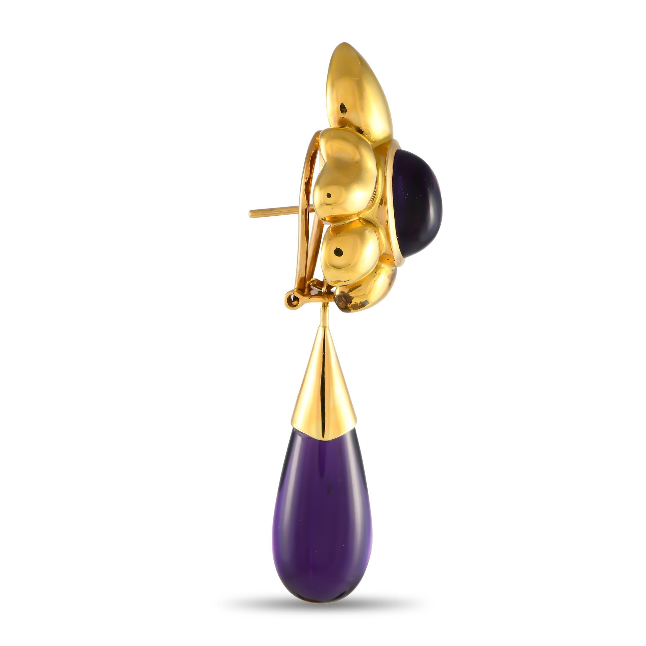 Opulent 18K Yellow Gold and captivating Amethyst gemstones come together beautifully on these enchanting earrings. Each one measures 2.5 long by 0.85 long, making them an ideal size for any occasion.This jewelry piece is offered in estate condition