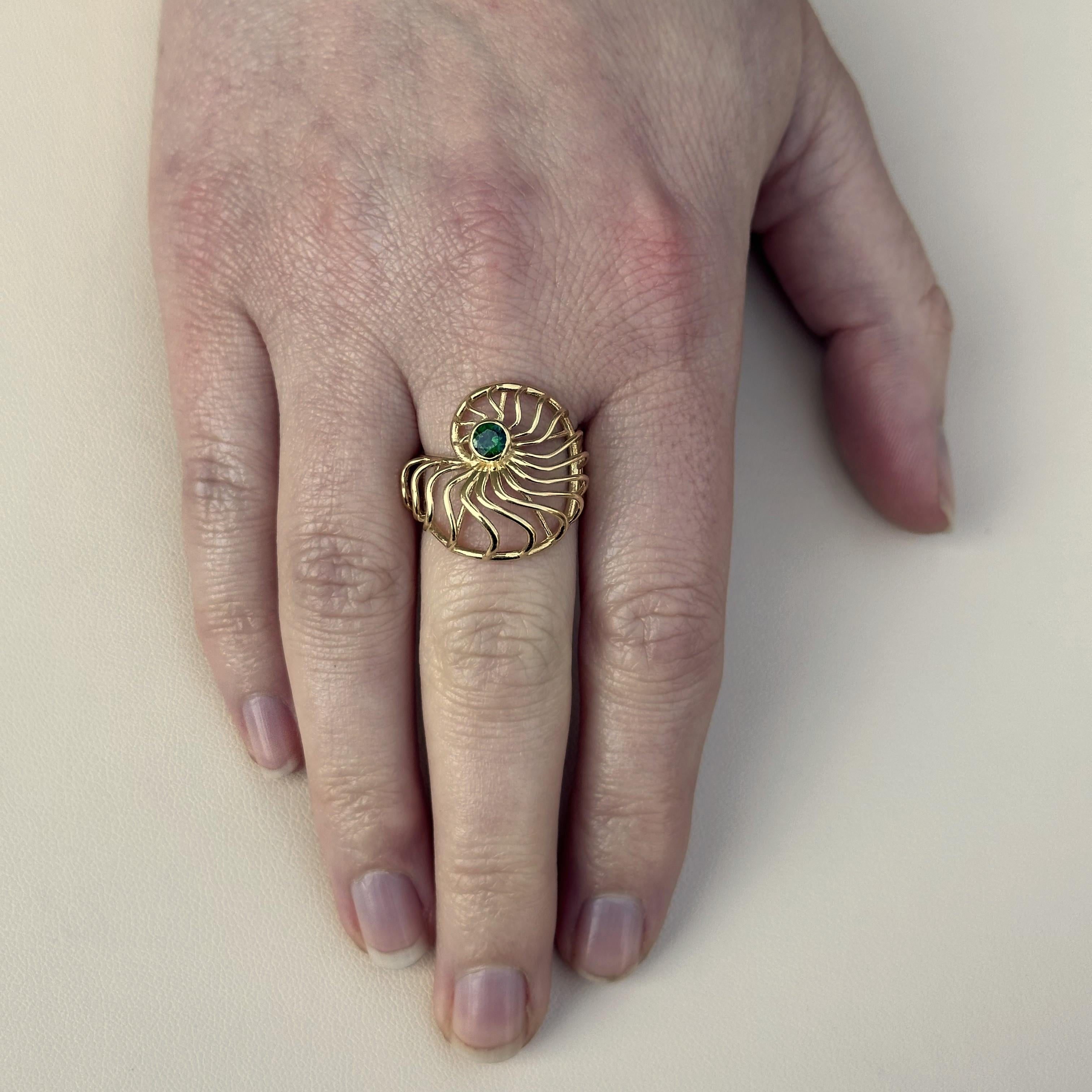 A size 6 1/2 18K yellow gold Ammonite style ring featuring a bezel set Tsavorite Garnet weighing .30 carats. This ring was designed and made by llyn strong.