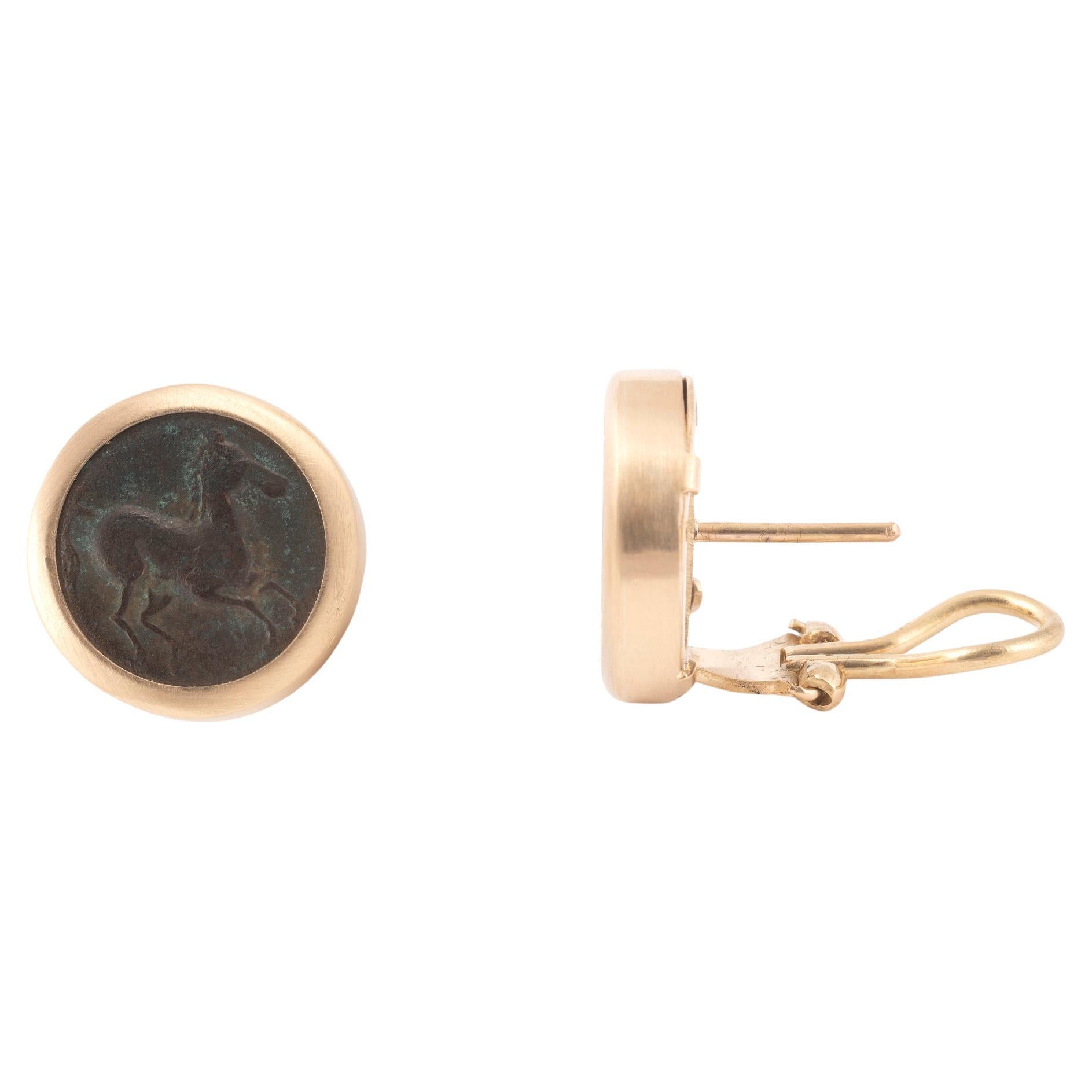 18kt yellow gold earrings with hammered finish featuring ancient authentic Tanit coin center.
Size: 16mm
Weight: 14.4gr.


The Tanit ring exudes elegance with a captivating bronze coin hailing from the esteemed Carthaginian Empire, minted in