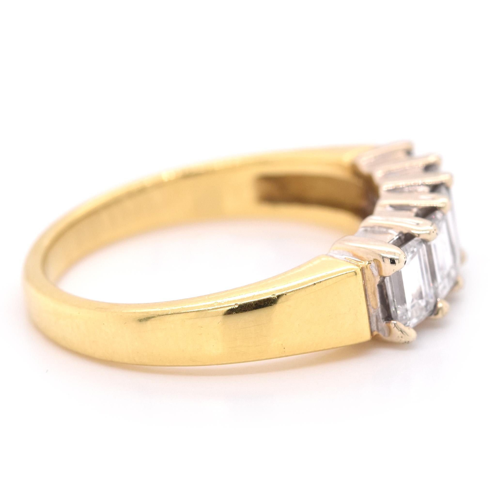 Designer: custom
Material: 18K yellow gold
Diamonds: 5 emerald cut = 1.50cttw
Color: G
Clarity: VS
Size: 8.5 (please allow two additional shipping days for sizing requests)
Dimensions: band measures 2.5mm in width
Weight: 6.2 grams