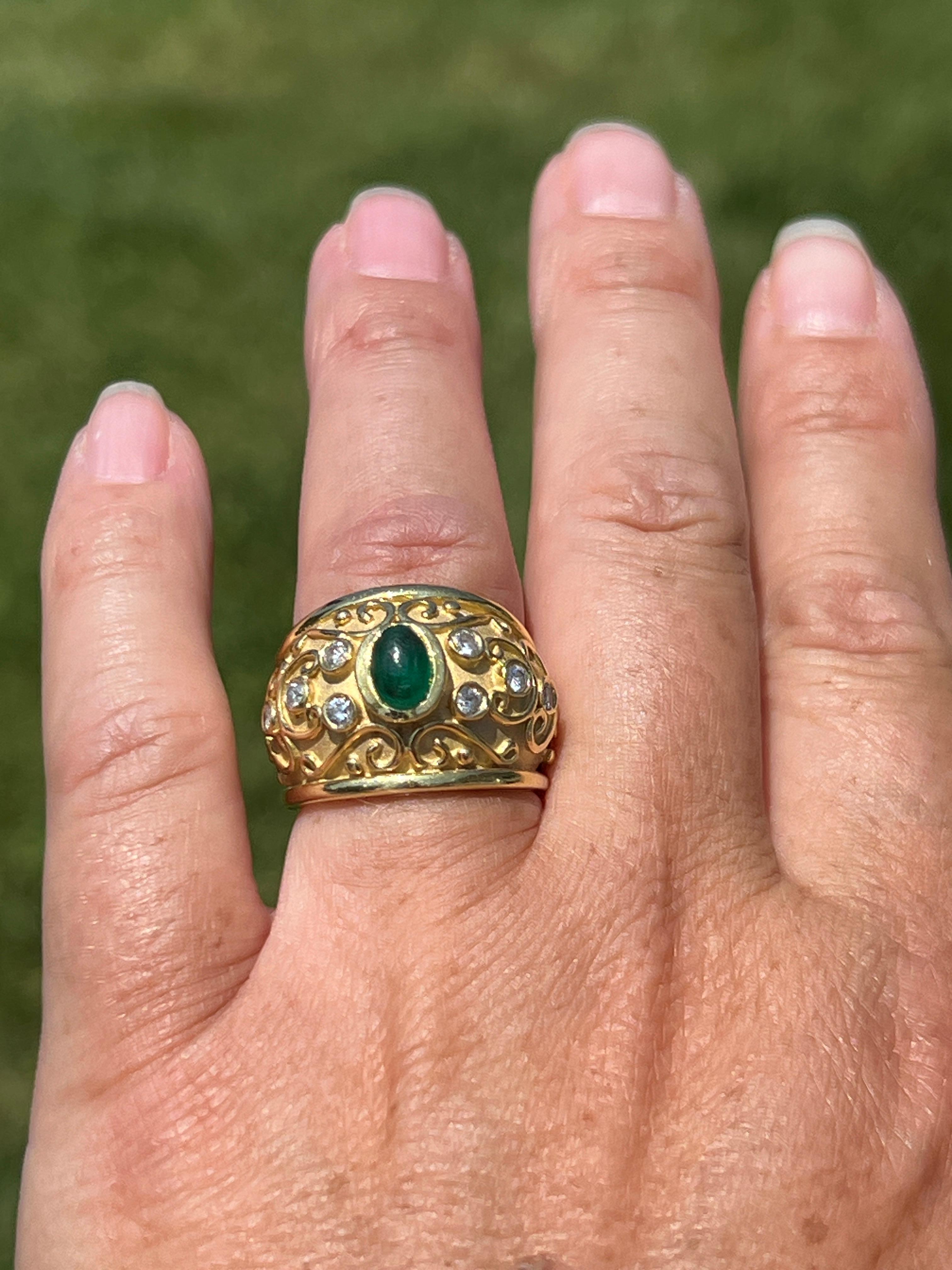 One 1980s 18 karat matte and polished yellow gold bezel ring set with one oval cabochon emerald approximately 0.95 carats and eight round brilliant diamonds approximately 0.30 total carat weight with matching J color and I1/2 clarity. This ring