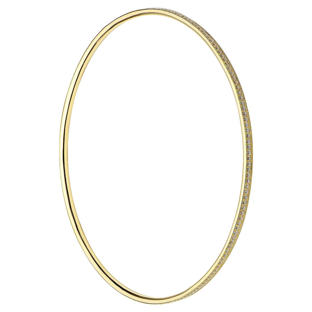 Bangles are so much fun to wear and add a special touch. This yellow gold and diamond bangle contains 6.5 grams of 18 karat yellow gold and 174 round VS2, G color diamonds totaling 0.90 carats. It is 2.5 inches in diameter and looks amazing alone or