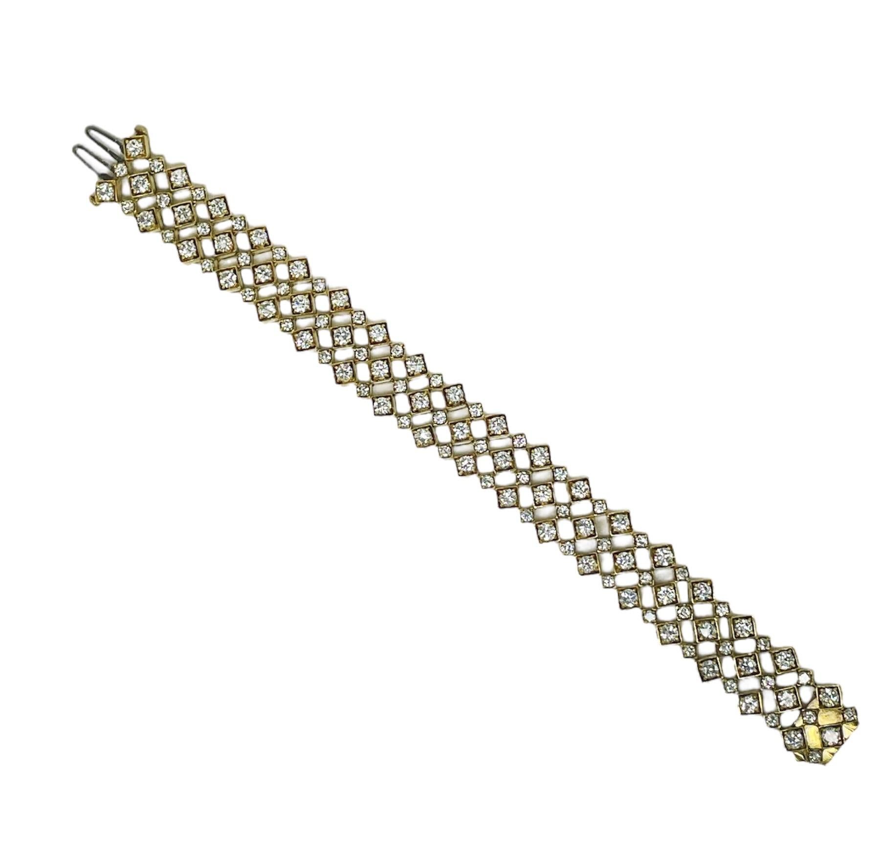 This fun geometric designed bracelet contains 108 top quality round brilliant cut diamonds weighing approximately 11.86 carats total. In an open work design and beautifully crafted in 18 karat yellow gold, this bracelet is extremely comfortable and