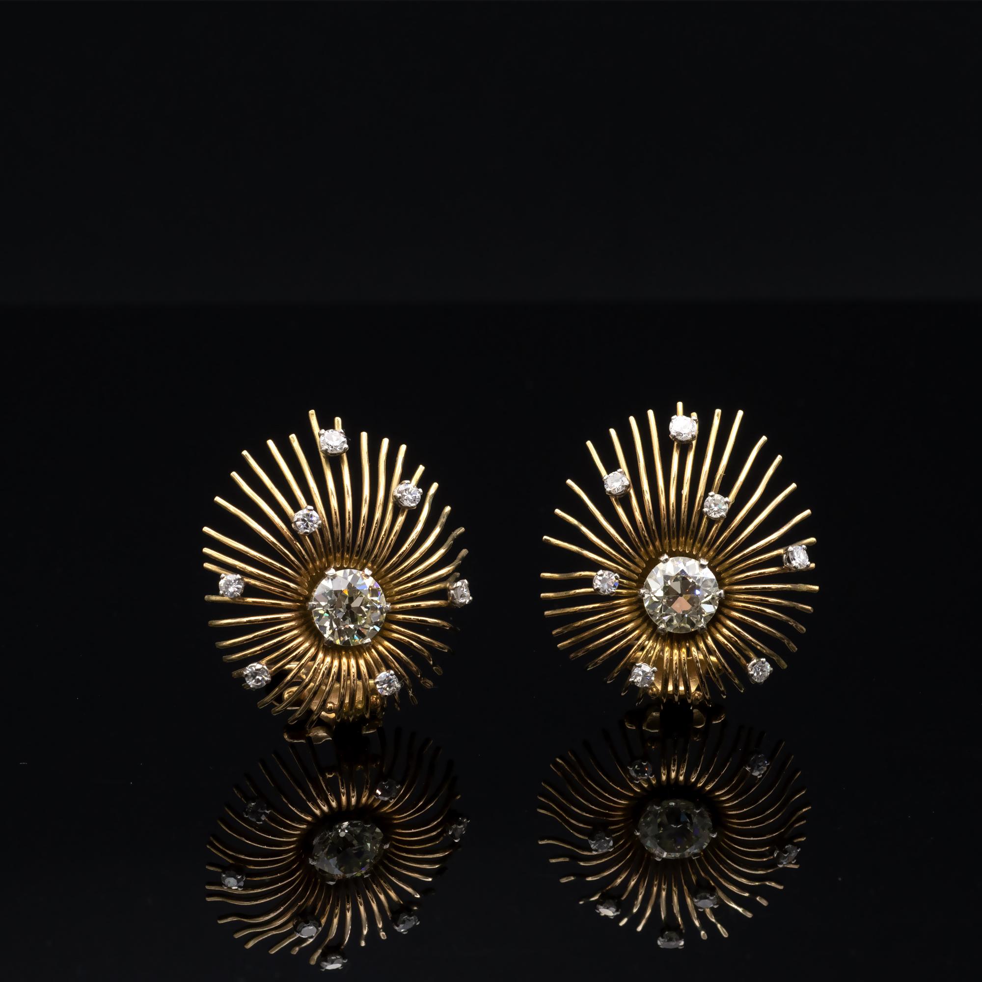 18k yellow gold earrings crafted in an exquisite feathery look showcasing two old European cut diamonds ( approx. 2.70 carat in total  KL VS2/SI1 ) . The central diamonds are wonderfully complimented by the diamonds sprinkled around the earring. All
