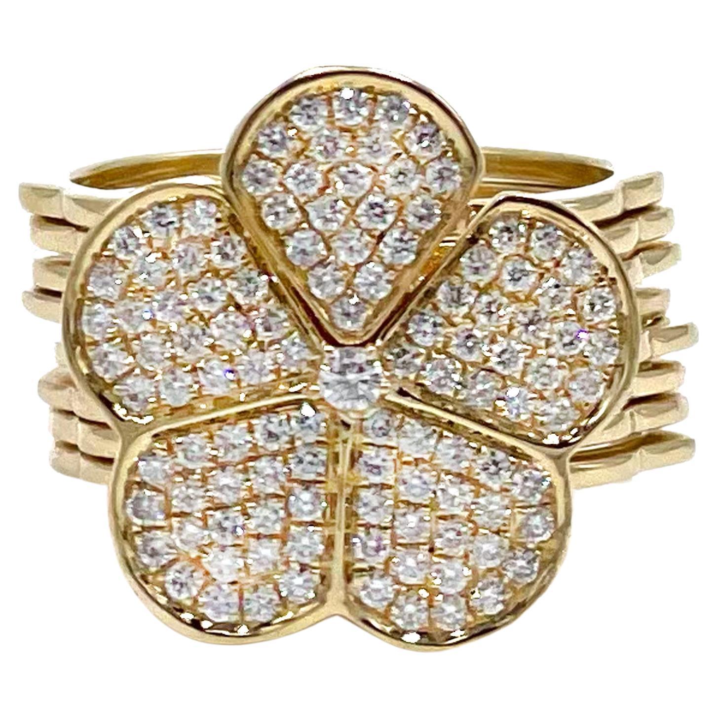 One piece of jewelry worn two different ways! This beautifully crafted 18K yellow gold flower ring converts into a flexible link bracelet.  It features a beautiful flower embellishment adorned with pave set diamonds weighing 0.69 carat total