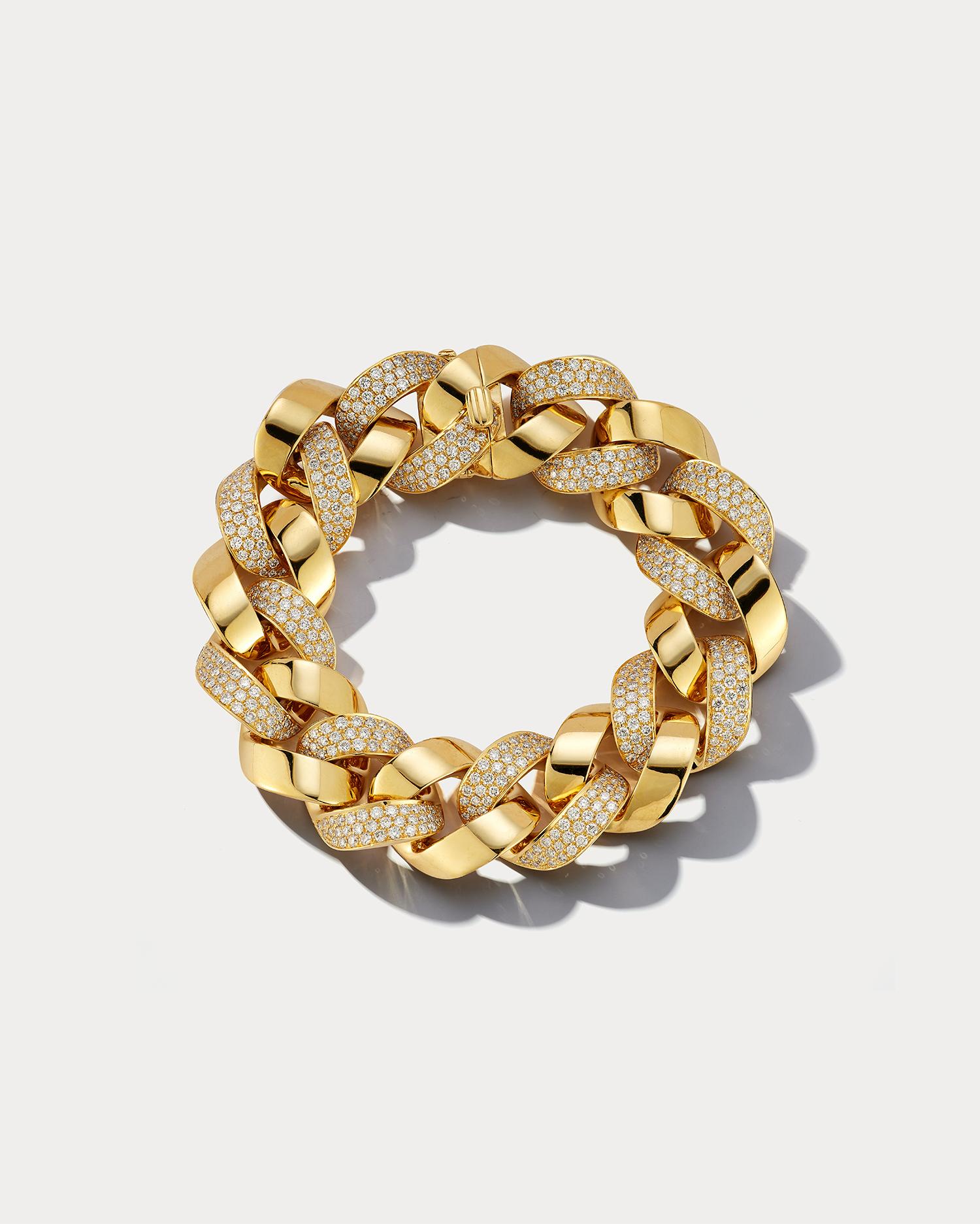 This exquisite Cuban link bracelet is a true statement piece that combines the luxury of yellow gold with the brilliance of diamonds. The bracelet is crafted from high-quality 18k yellow gold, which has a bright and lustrous appearance that