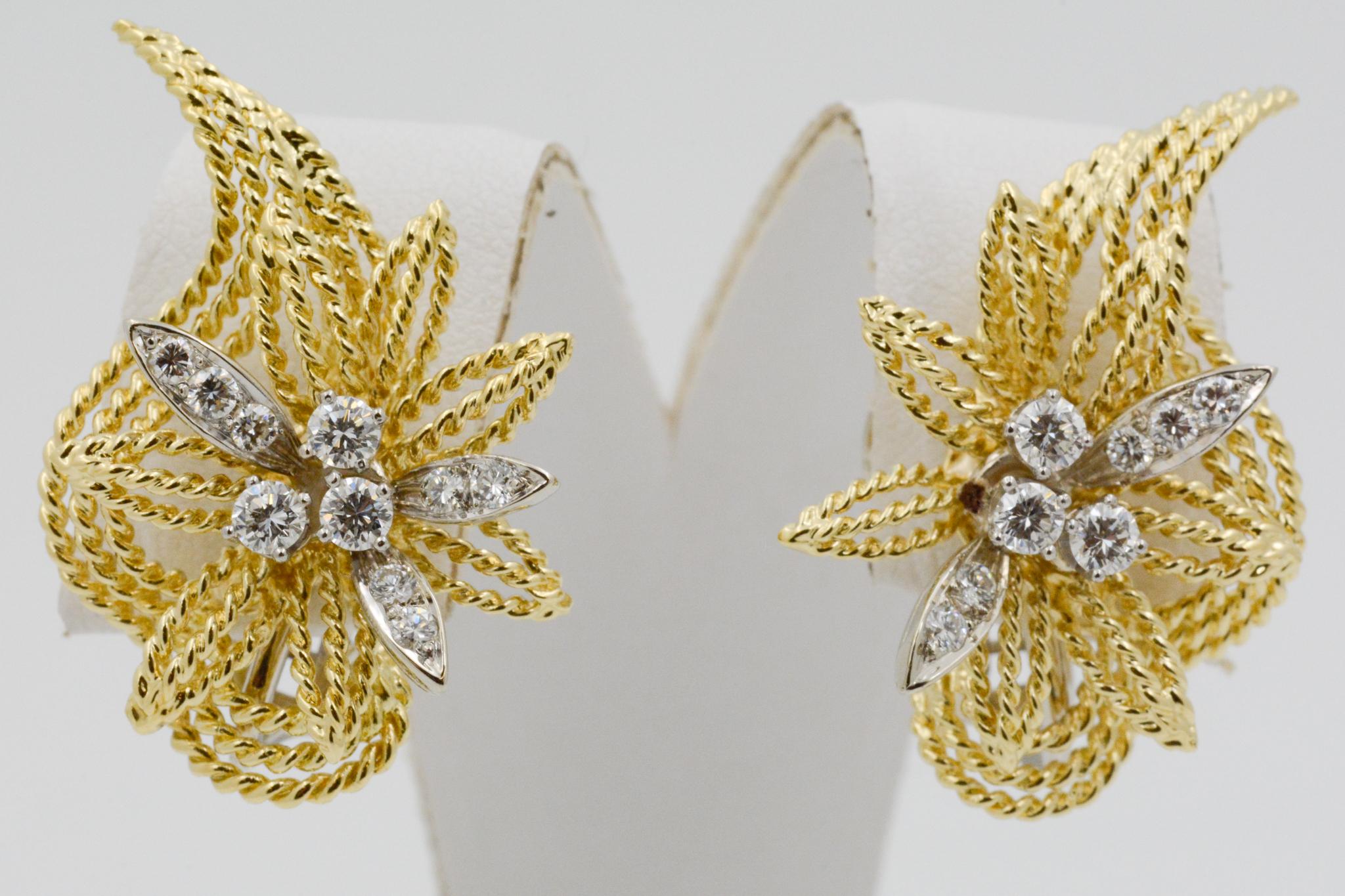 Exclusively from the Eiseman Estate Collection, these 18k yellow gold earrings have a textured floral leaf motif, featuring 16 round brilliant cut diamonds, weighing 1.00 carats GH SI. The earrings have clip backs. 