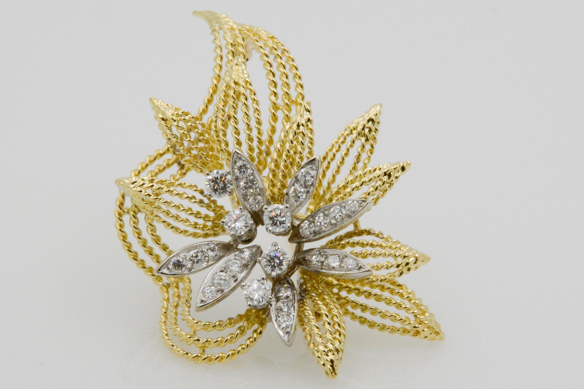 Exclusively from the Eiseman Estate Collection, this 18k yellow gold pin has a textured floral leaf motif, featuring 27 round brilliant cut diamonds, weighing 1.40 carats with GH coloring and SI clarity. 