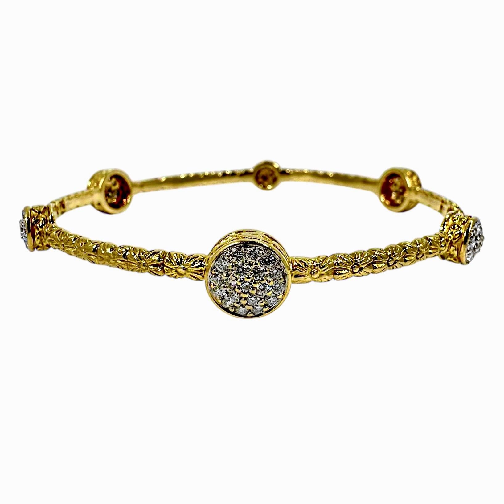 This wonderful 18K yellow gold and diamond narrow bangle bracelet is a true foliate delight. Six circular stations, 3 larger and three smaller, alternate around the bracelet. Approximately 75 modern round brilliant cut diamonds are set into the six
