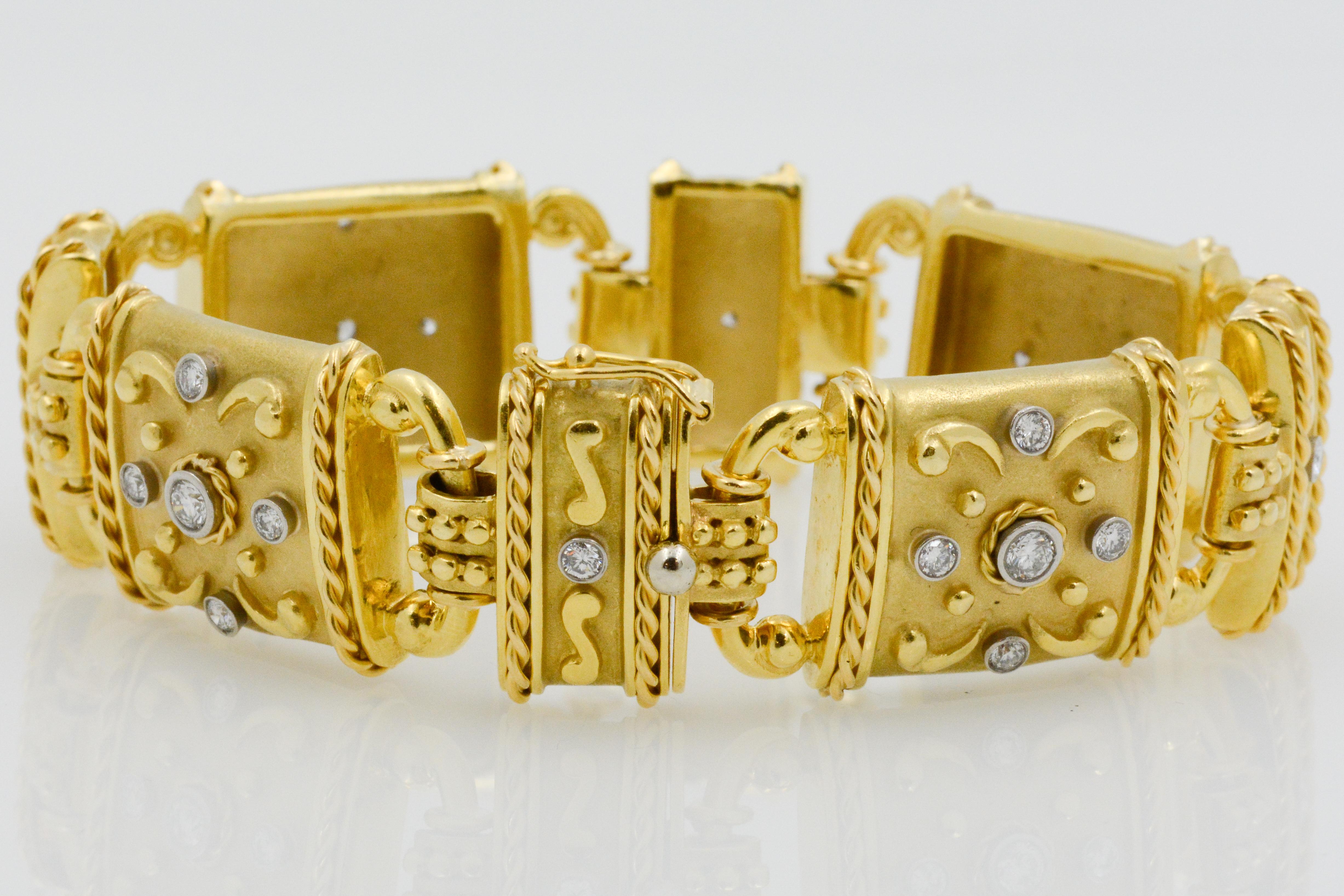 24 round dazzling diamonds with a combined weight of 1.50 carats are accented with 18k yellow gold scroll work. The flexible bracelet is separated by eight linked panels to create a charming and elegant design. 