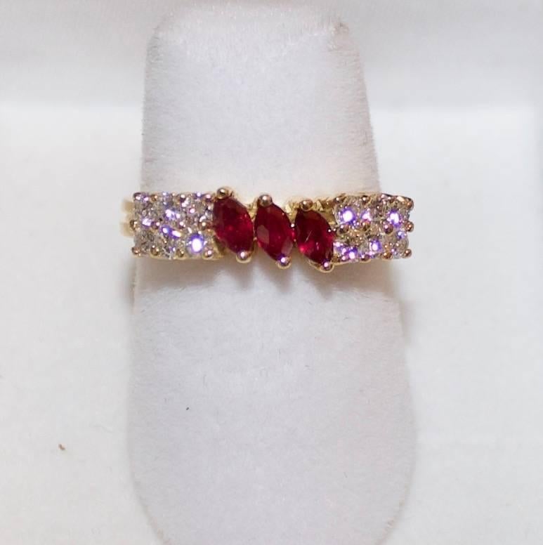 18k Yellow Gold and Diamond Ring
Three Round Marquise Cut Rubies weighing .30 carats approximately
Twelve Round Brilliant Cut Diamonds weighing ..50 carats approximately GH VS-SI
