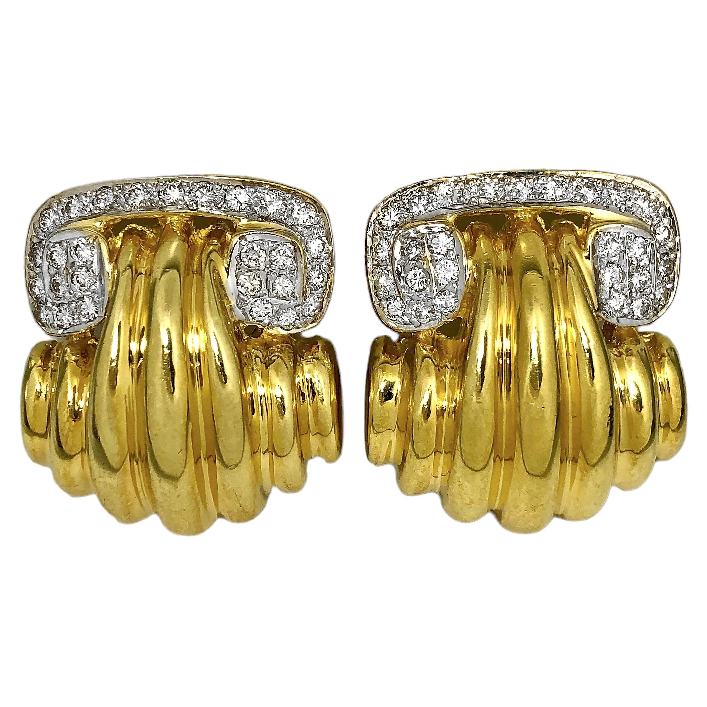 This striking pair of 18K yellow gold scroll top earrings are reminiscent of Ionic columns, in design. Set with sixty brilliant cut diamonds weighing an approximate 1.50ct total of overall G/H color and VS1 clarity.  Each earring is stamped 18K on