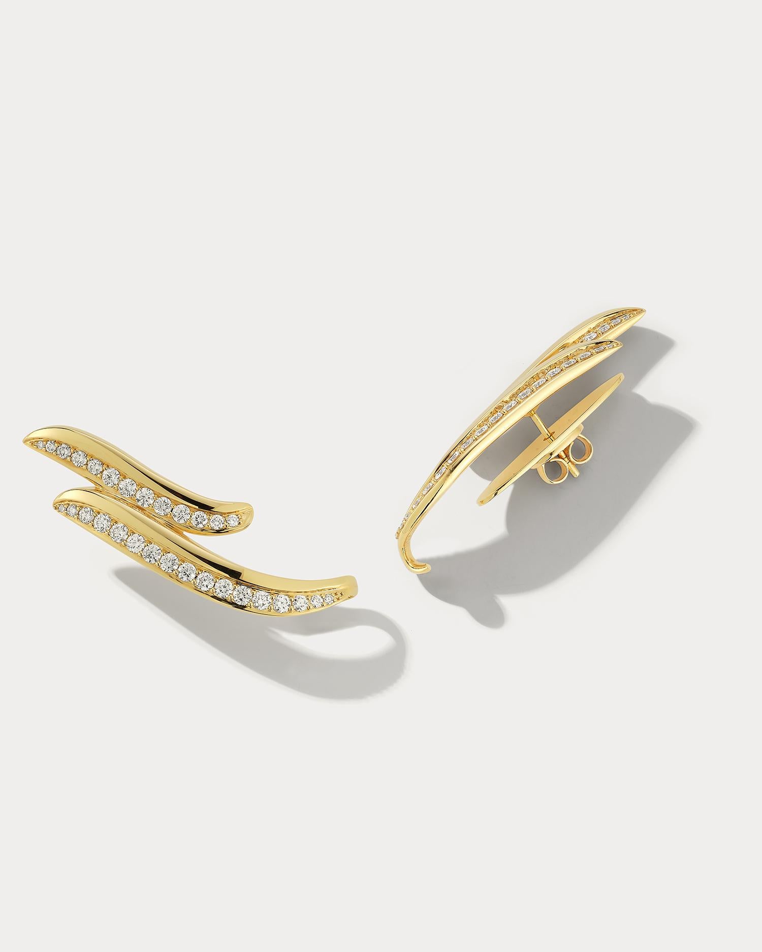 These stunning earrings are crafted from 18k yellow gold and feature a unique wave design with shimmering diamonds across. The earring sits angular on your ear giving it a stylish vibe. The earrings have a secure post and butterfly back, ensuring