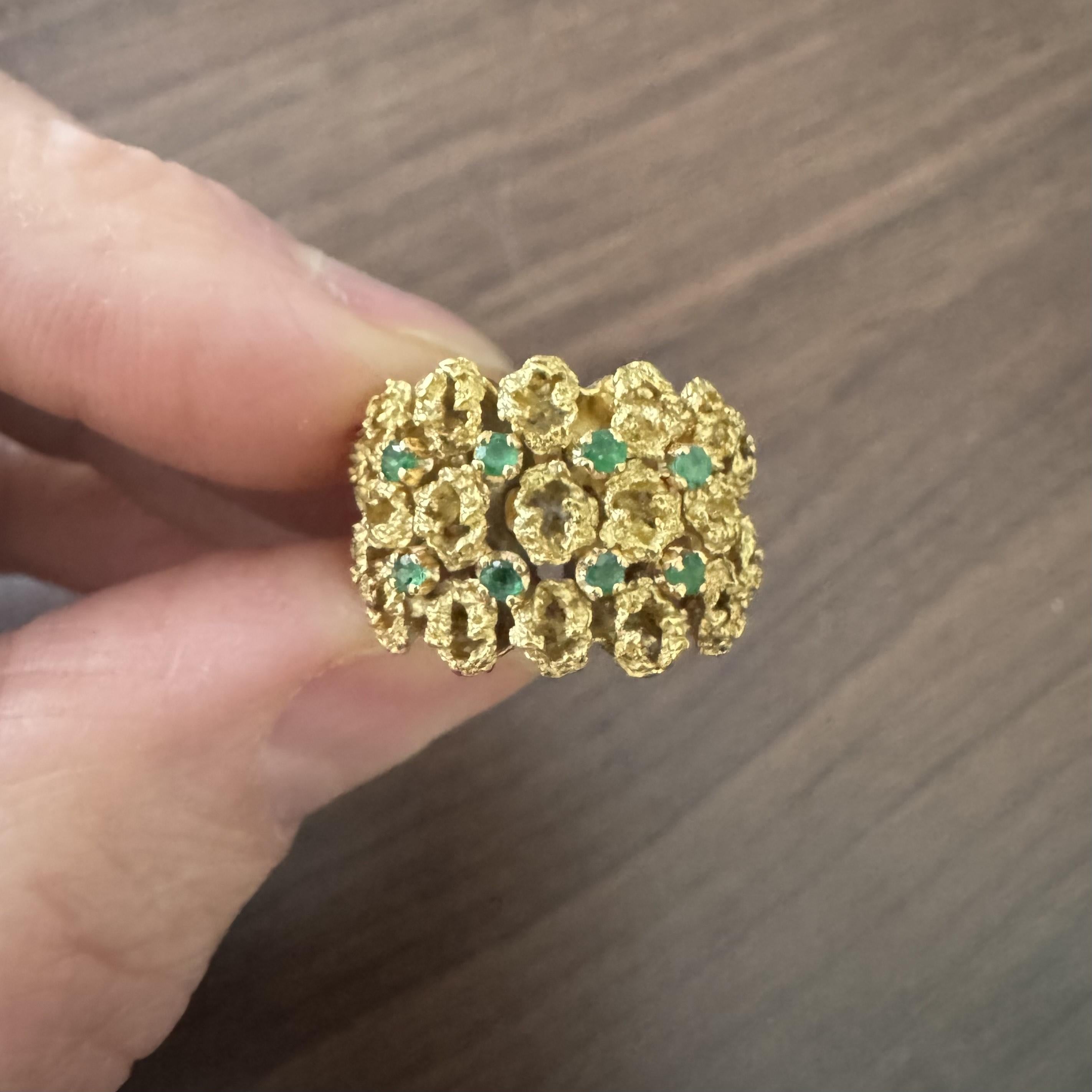Condition:  Excellent Condition, Professionally Cleaned and Polished
Metal:  18k Gold (Marked, and Professionally Tested)
Weight:  9.7g
Gemstones:  Round Cut Emeralds
Width:  14mm at face, 7mm at back
Size:  4
Markings:  