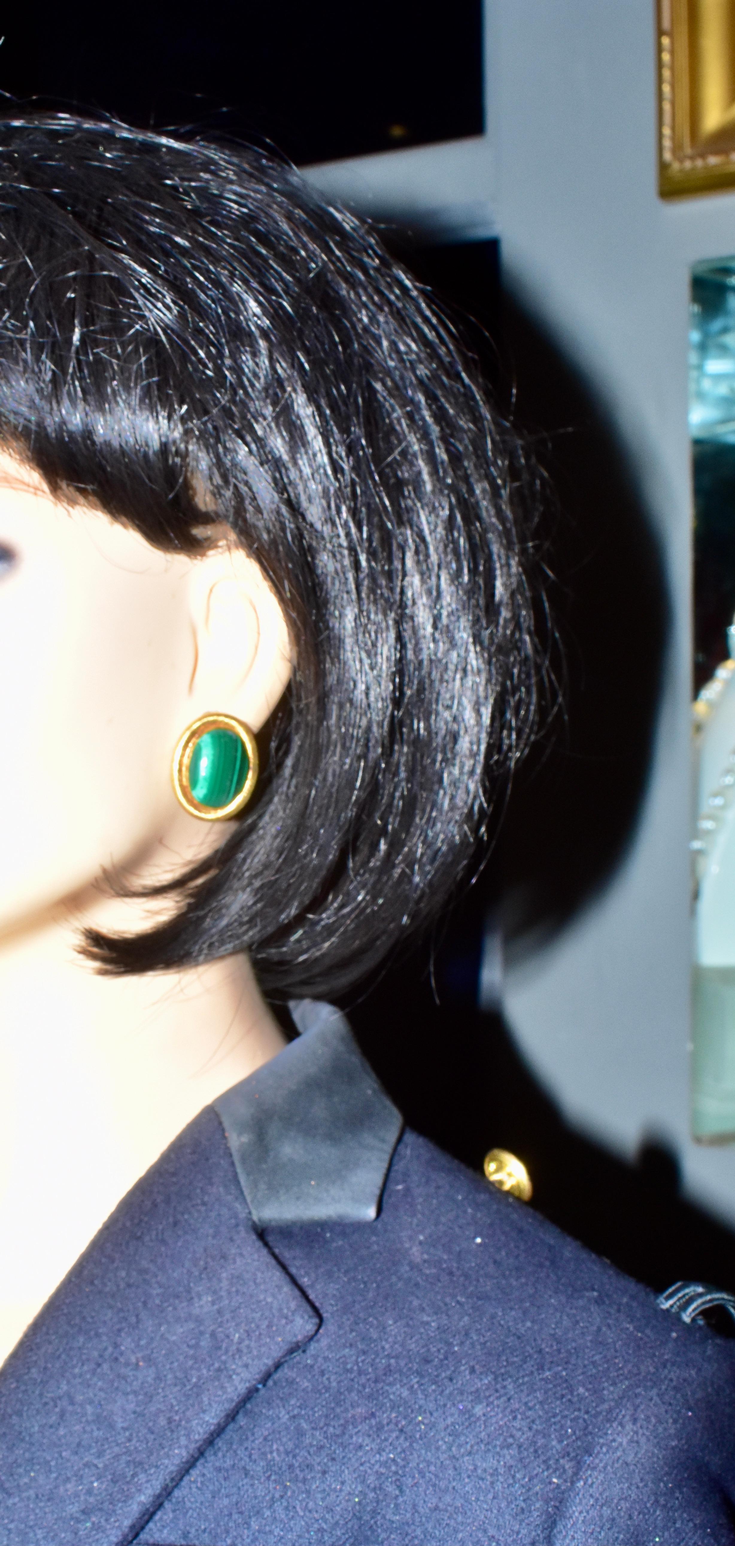 18K gold with a ribbed satin finish and natural Malachite earrings, these oval earrings center fine natural Malachite which is then rimmed in textured 18K yellow gold.  These earrings measure just over 1 inch in length.  They are in fine condition,