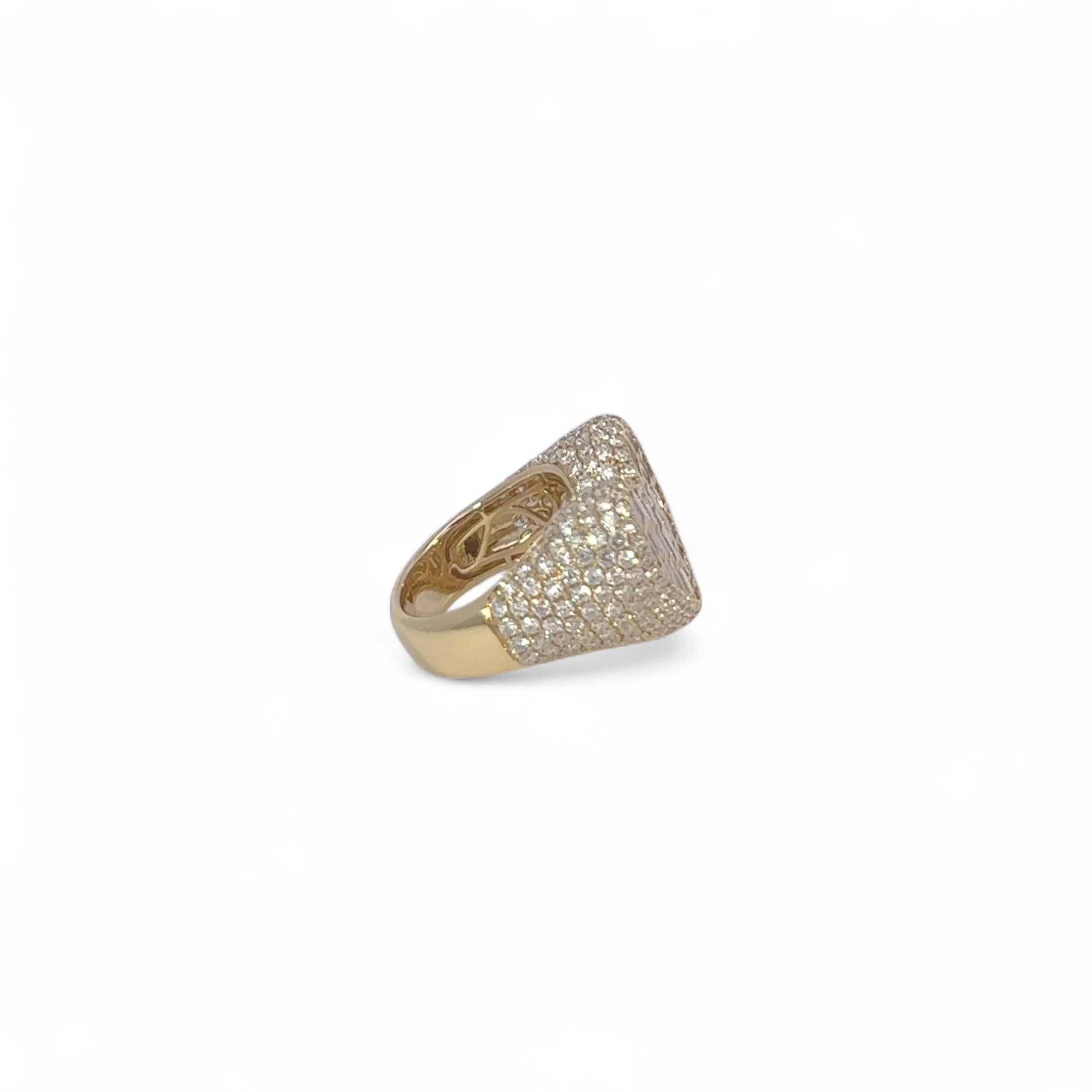 Discover an exquisite 18 karat yellow gold signet ring, featuring 2.49 carats of shimmering natural pavé diamonds and 1.20 carats of vibrant baguette cut diamonds at the center of the heart-shaped signet. This captivating statement piece combines
