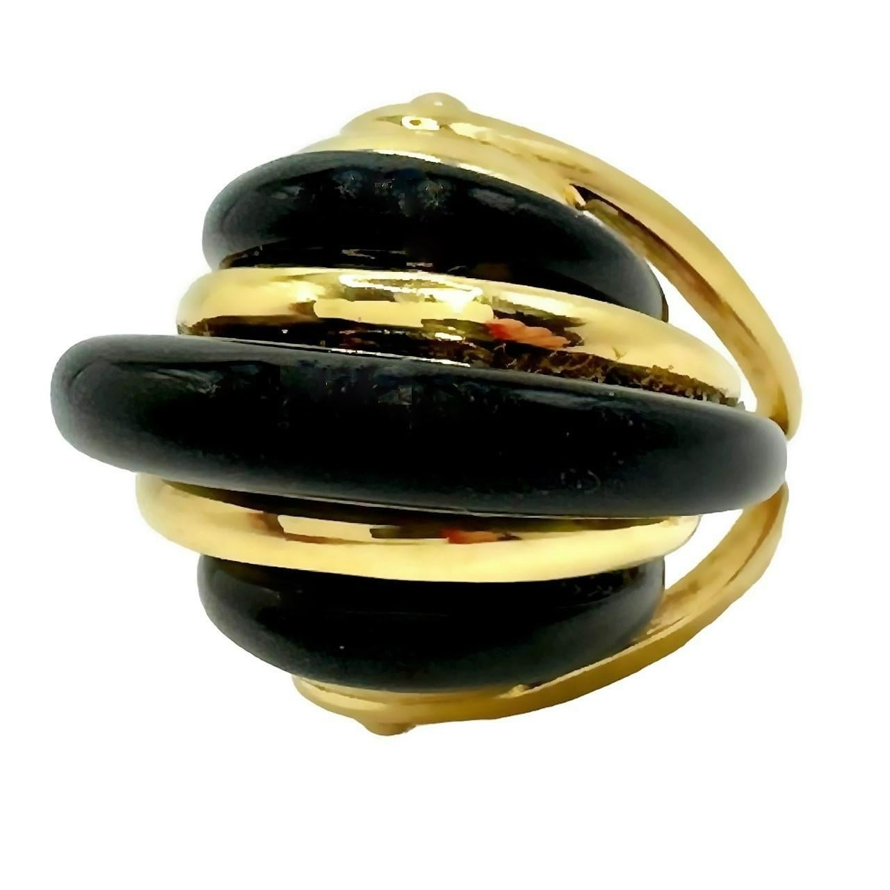 This unique and dramatic Mid-20th Century 18k yellow gold and onyx modernist ring is pure drama. The onyx center of it's design area soars to a 
full 3/4 inches above the finger. The ring is stylish, with alternating bands of gold and black onyx