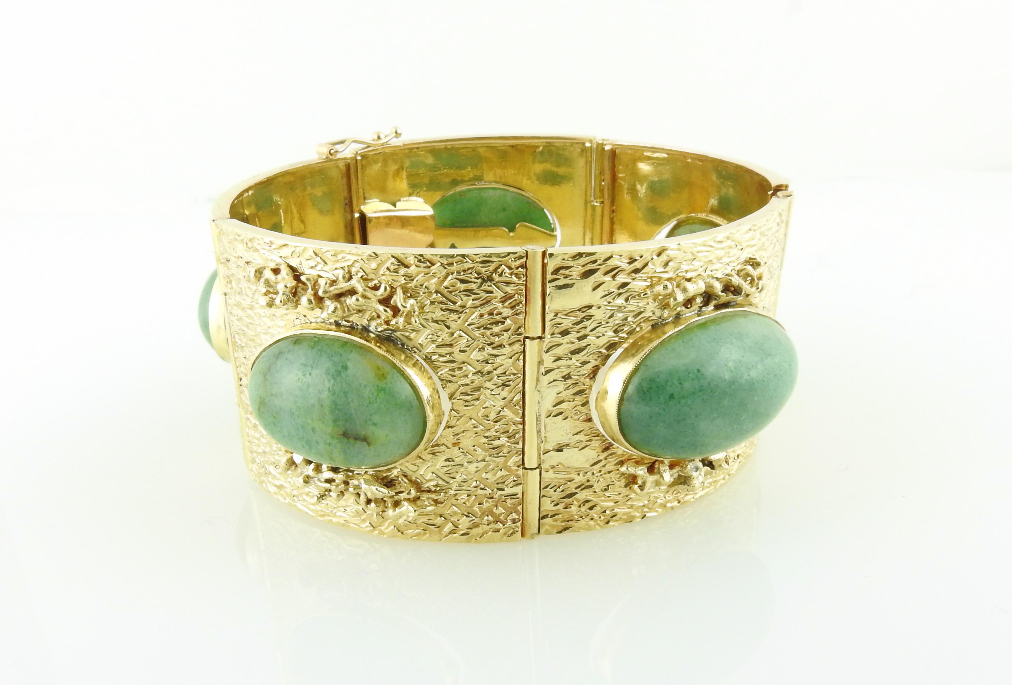 Vintage 18K Yellow Gold and Cabochon Jade Wide Link Bracelet

This ornately detailed wide panel bracelet is set in textured 18K Yellow Gold 

Each panel has a bezel set cabochon oval jade stone approx. 21m x 14mm each

Bracelet is approx. 31.3 mm