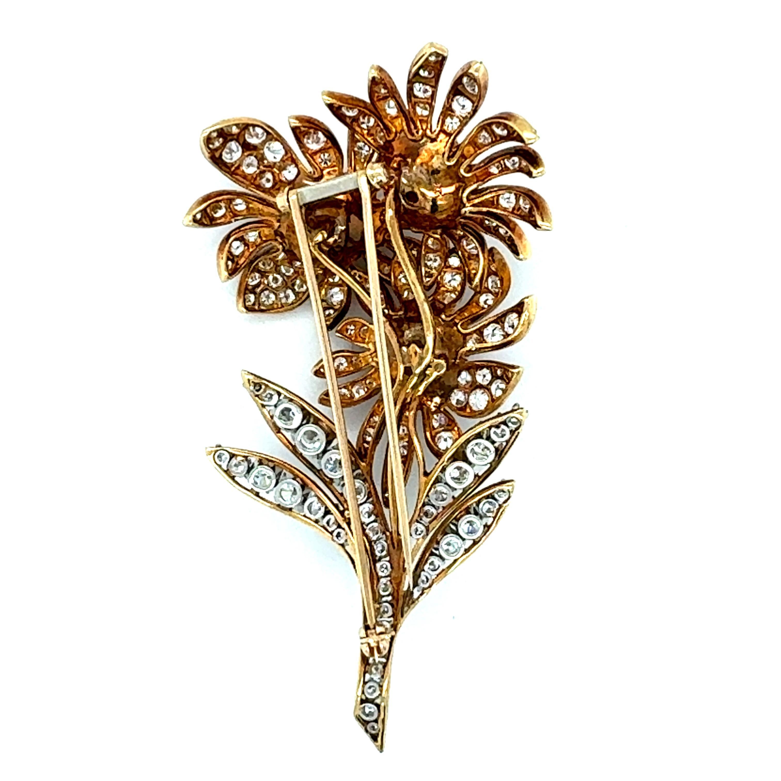 This exquisite 18K yellow gold and platinum floral sunburst brooch from the 1970s captures the bold elegance and exceptional craftsmanship of the era. Featuring 127 transitional round brilliant cut diamonds totaling 4.50 carats, with F-G color and