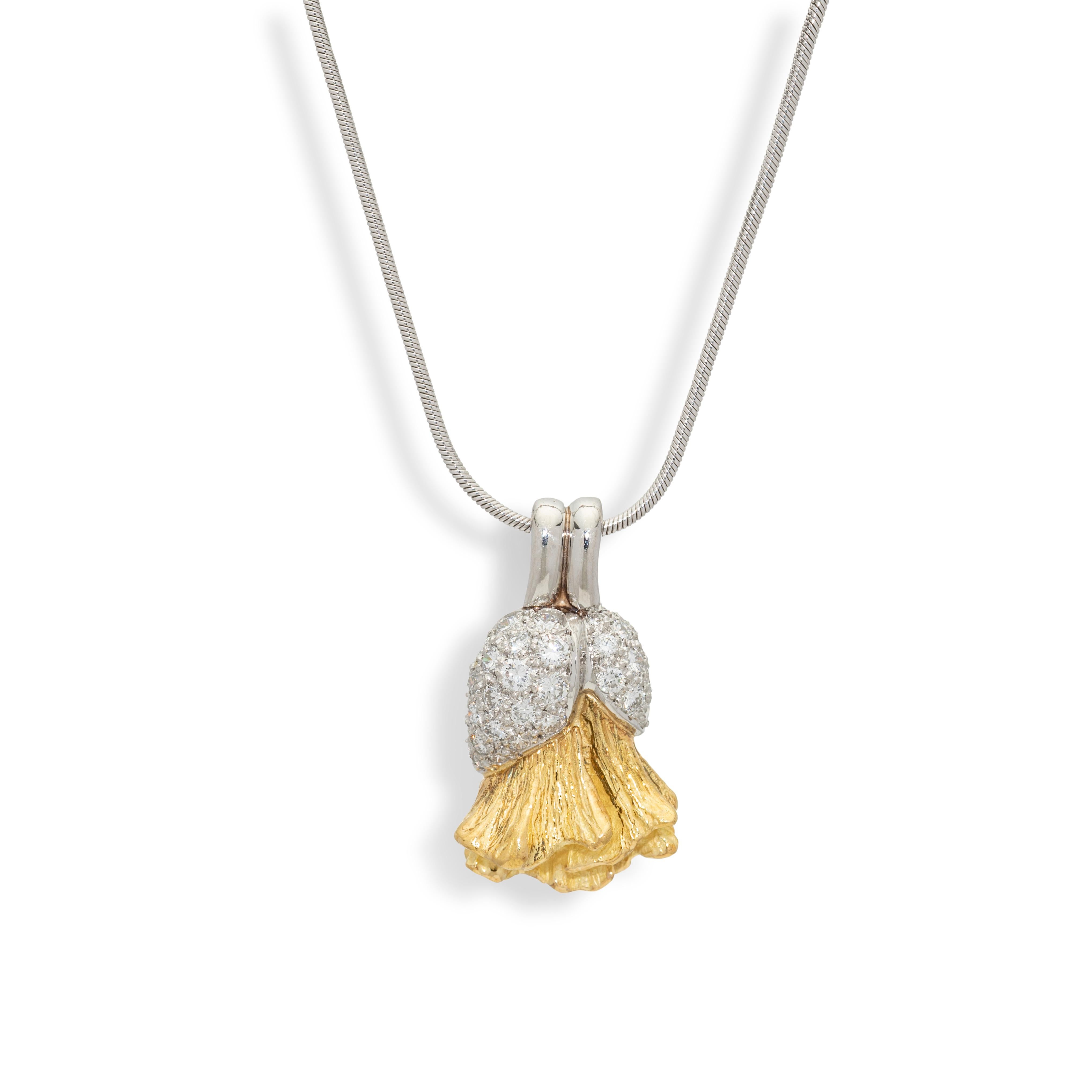 This magnificent pendant is part of the Poppy collection and features a finely carved Poppy flower in 18k yellow gold emerging from a diamond encrusted platinum bud for a contrast in colour and textures. Pair this wonderful work of art with the