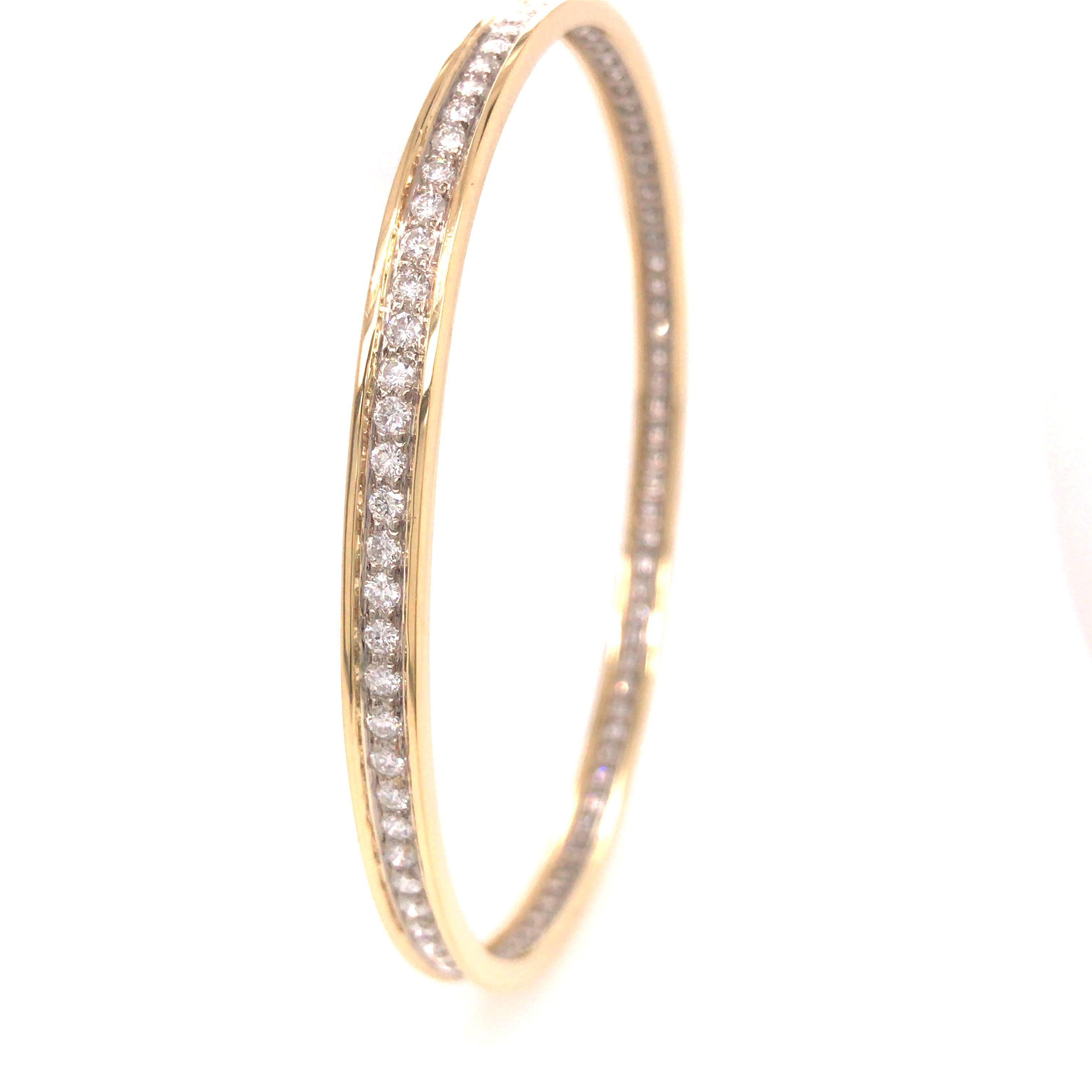 Round Diamond Handmade Bangle in 18K Yellow Gold and Platinum.  Round Brilliant Cut Diamonds weighing 3.50 carat total weight G-H in color and VS in clarity are expertly channel set.  The Bangle measures 7 3/4 inch in inner circumference and 3/18