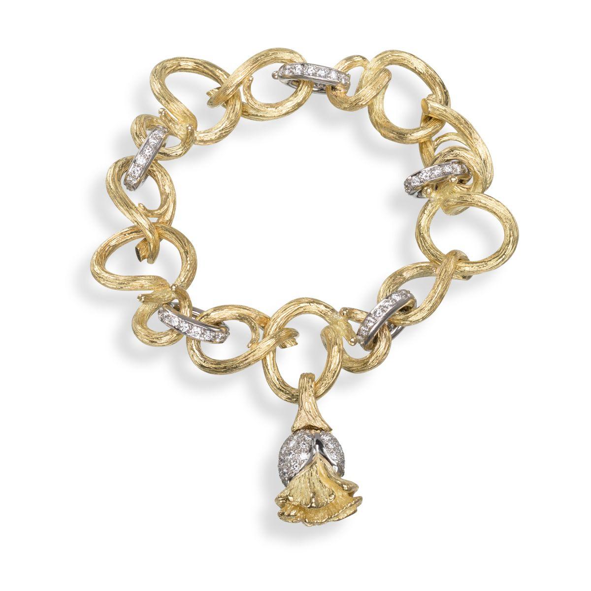 Inspired by Nature, this fascinating piece is part of the Poppy collection. The textured intertwining links in 18k yellow gold create a vine-like landscape from which the Poppy bud blooms in platinum and gold. Platinum bands with shimmering diamonds