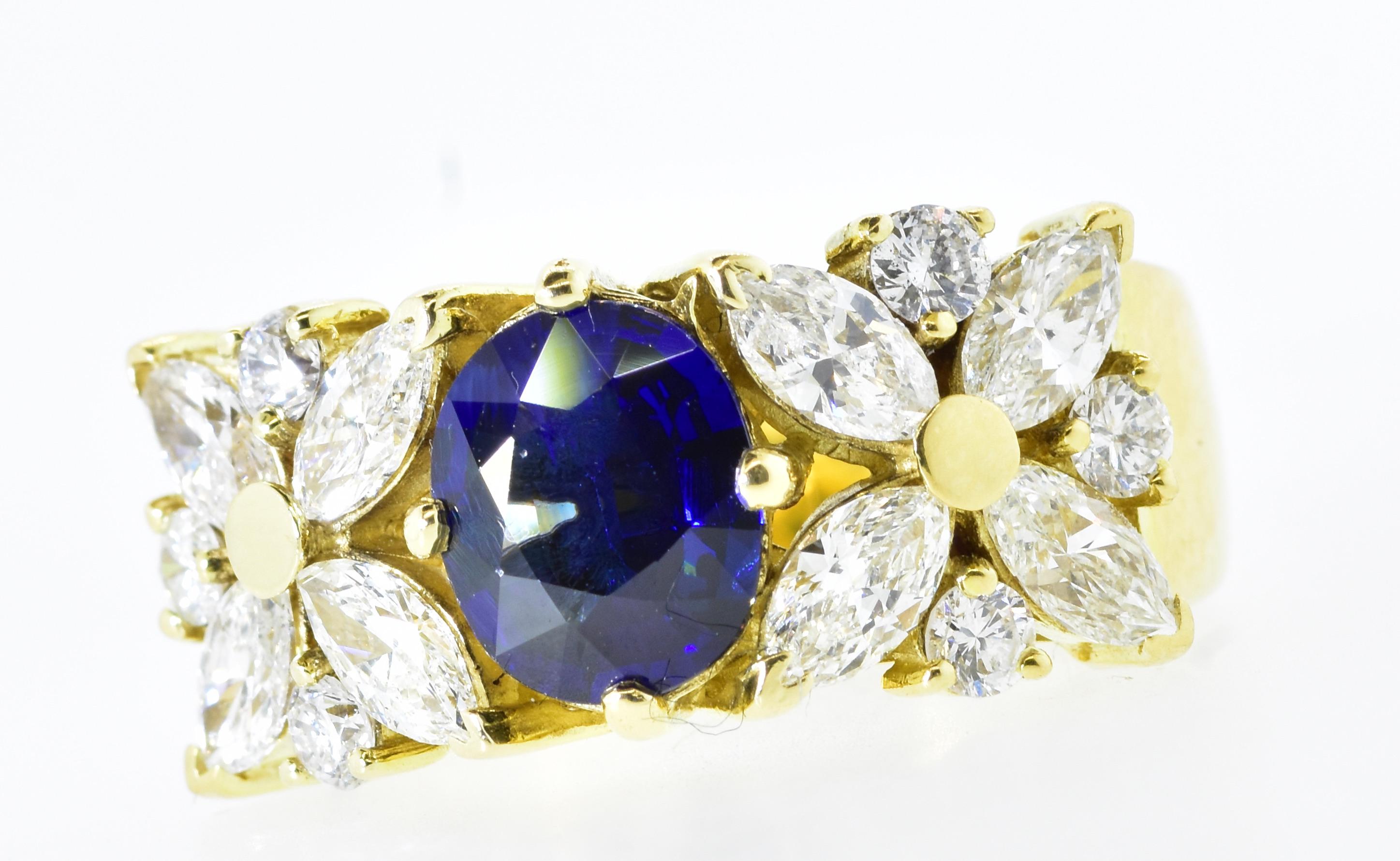 Diamond and Royal Blue Sapphire prong set in a contemporary 18K yellow gold ring.  The fine white diamonds are both round brilliant cut and marquis cut.  The diamonds average H (near colorless), and VS1 (very slightly included to the first degree). 
