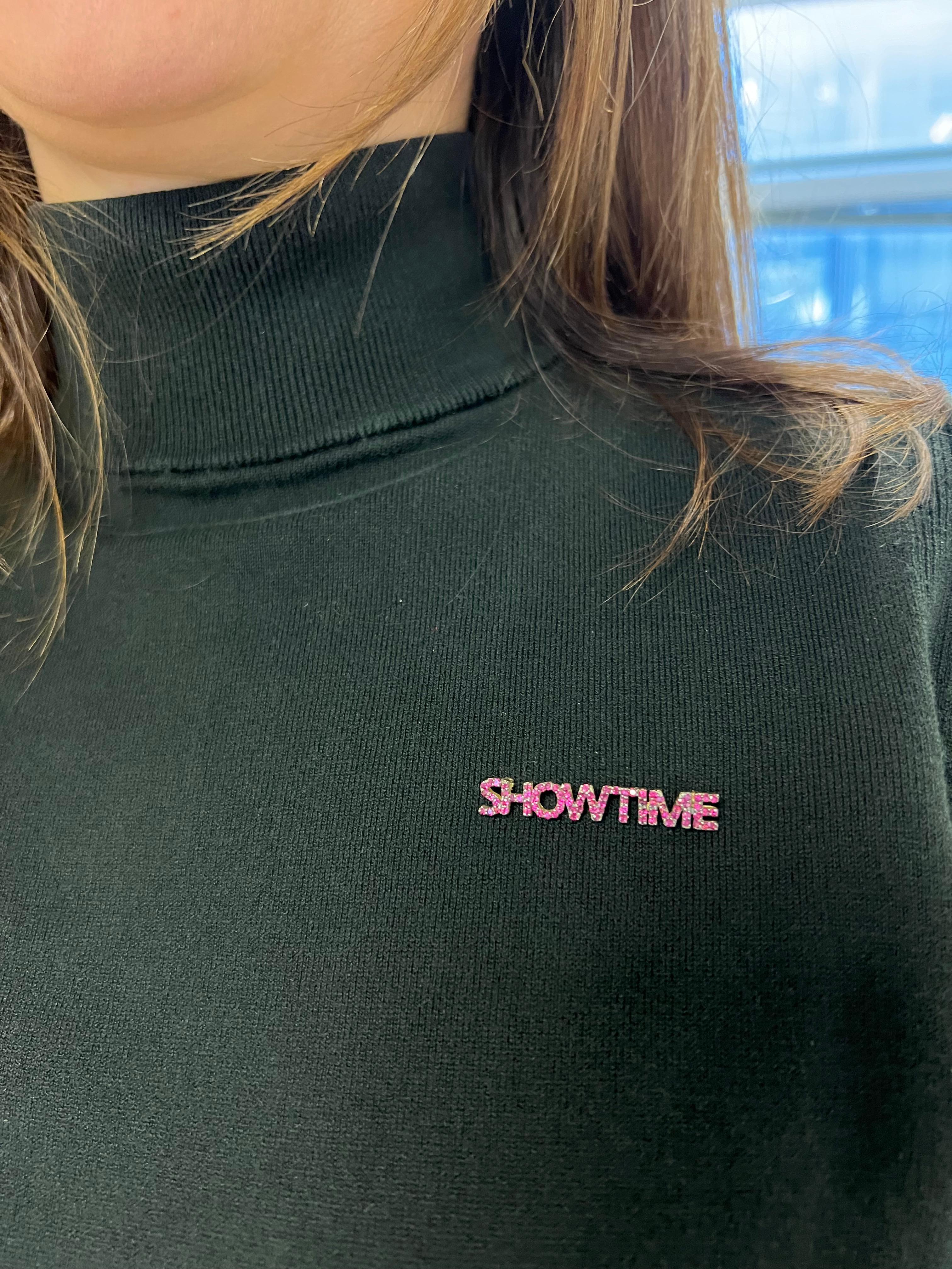 Introducing our SHOWTIME pin, a dazzling expression of luxury and flair in 18k yellow gold. This distinctive pin is adorned with 86 round rubies, each carefully selected to radiate a deep, alluring red hue. The captivating arrangement of these