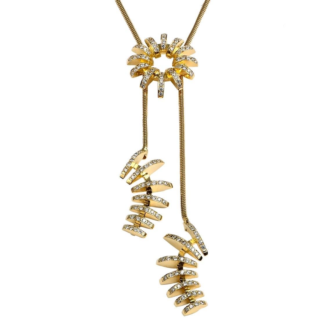 The 'Overflow' sautoir necklace is crafted in 18k gold, hallmarked in Cyprus. This stunning, contemporary sautoir comprises three individual pieces set with diamonds held together be a snake chain. The necklace features a box and tongue fastening