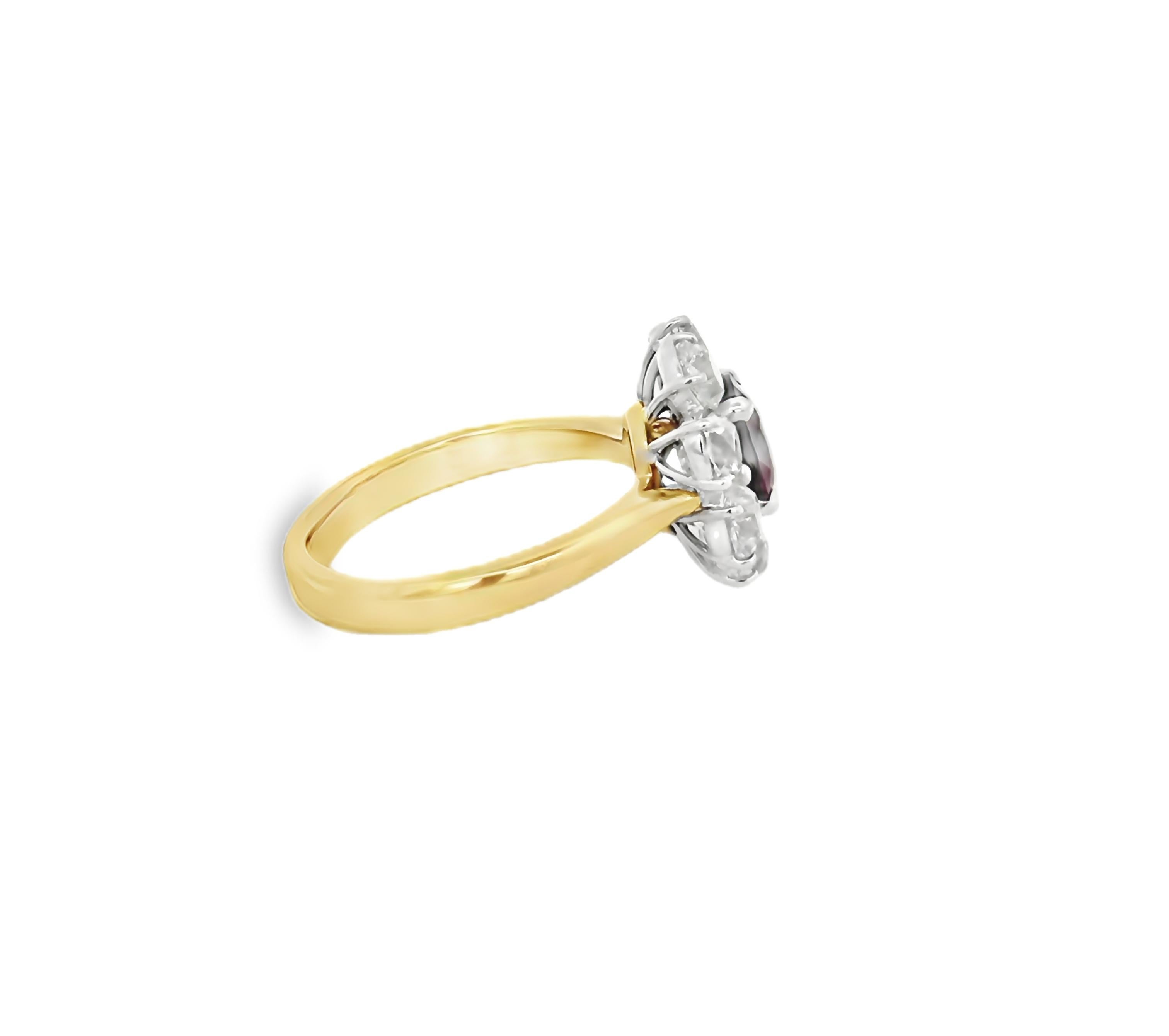 This exquisite antique ring presents a captivating design centered around a stunning 1.24-carat oval ruby set in luxurious 18k yellow gold. Surrounding the vibrant ruby are 2.02 carats of old European cushion cut diamonds, each carefully faceted to