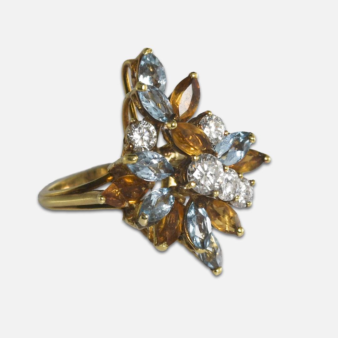 Cocktail ring in 18k yellow gold with diamonds and colored stones.
Marked 18k and weighs 6.8 grams.
There are five round brilliant cut diamonds,1-.33ct, 3x .15ct, 1- .12ct, .85 carats total weight.
All are G color, si clarity, and very good cuts.
On