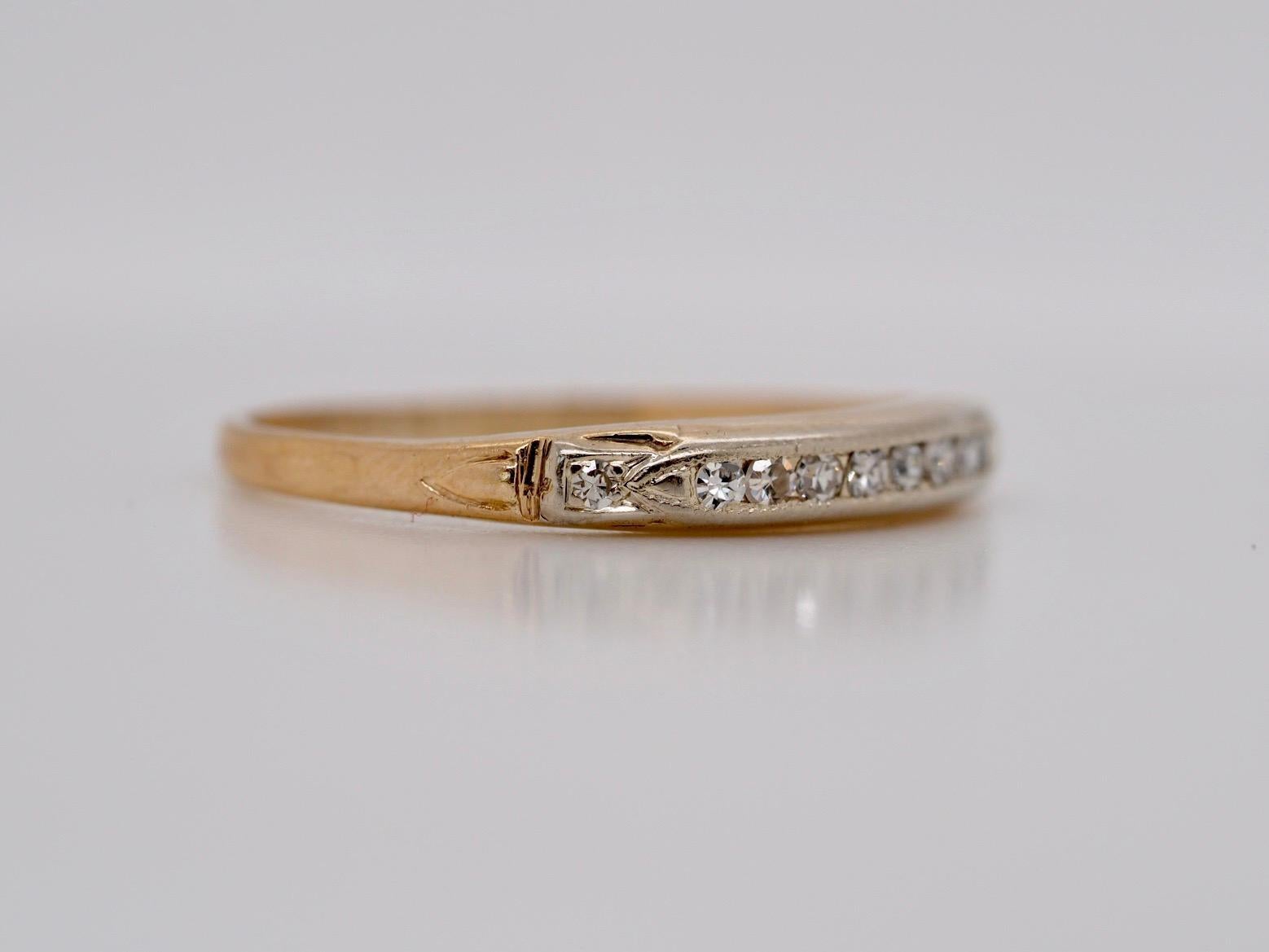 This classica art deco 14K Yellow Gold band includes 10 channel set antique single cut diamonds across the top of the band. It is a beautifully made piece in excellent condition. We are able to size this ring up or down for an additional $30.00 fee