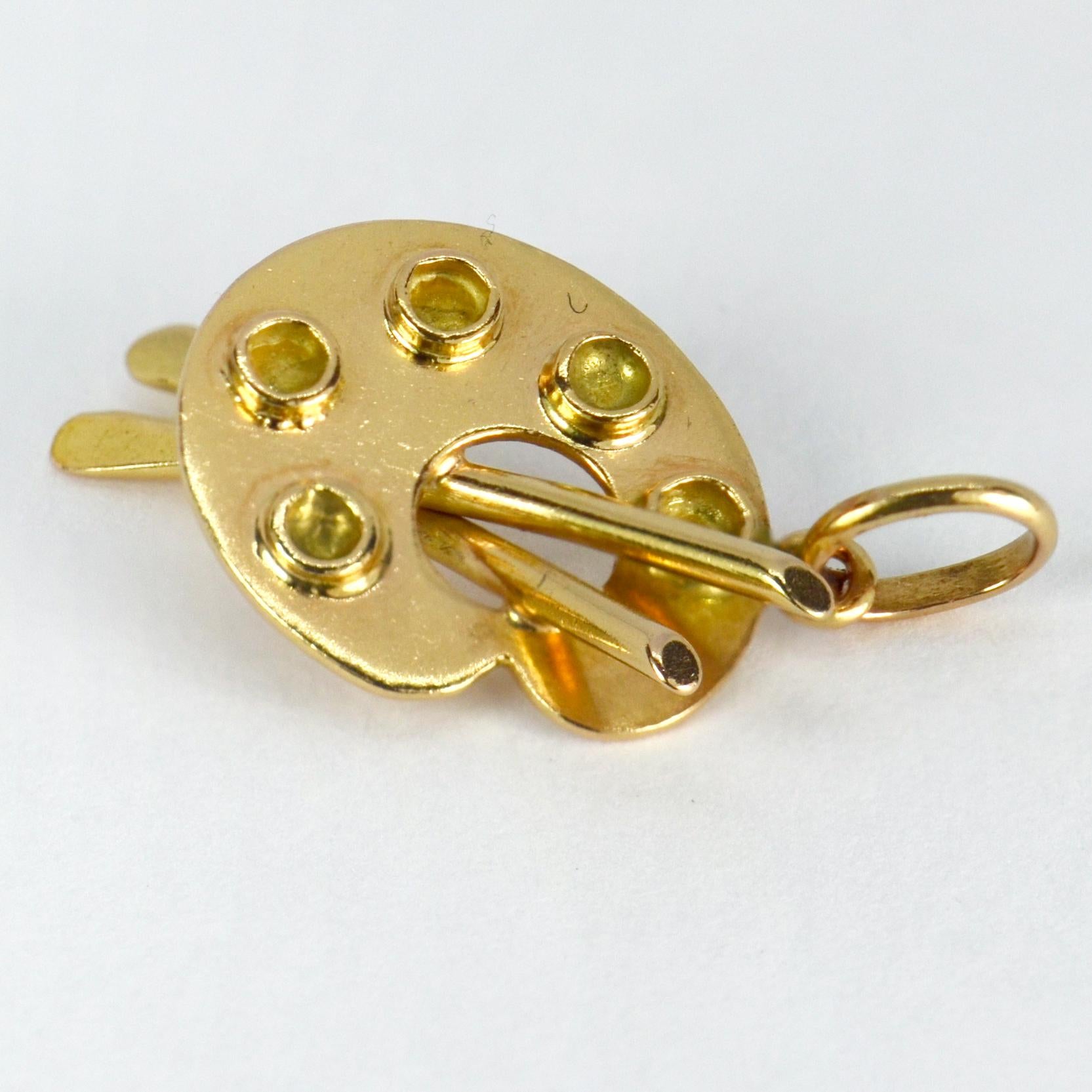 An 18 karat (18K) yellow gold charm pendant designed as an artist’s palette. Unmarked but tested for 18 karat gold. 

Dimensions: 2.1 x 1.3 x 0.65 cm
Weight: 1.91 grams
