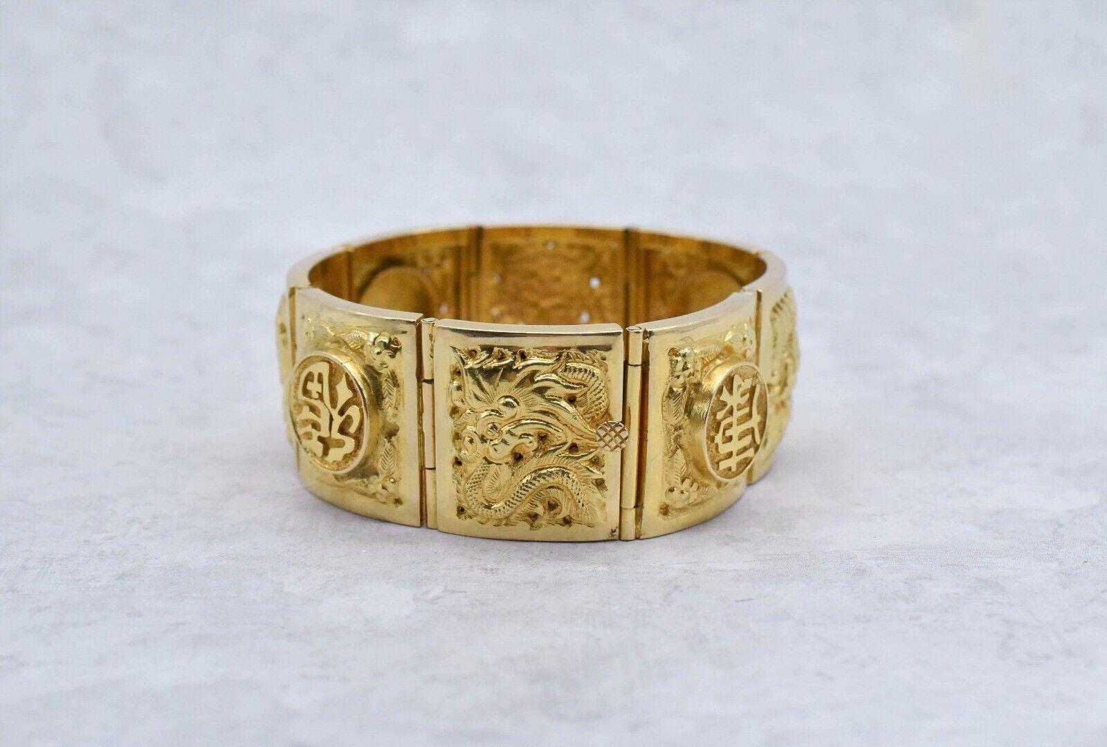 Highly detailed in a rich 18k yellow gold, this beautiful bracelet features 9 intricate plaques. The panels alternate between several art pieces depicting dragons and florals and various Chinese symbols commonly recognized with meanings such as Good