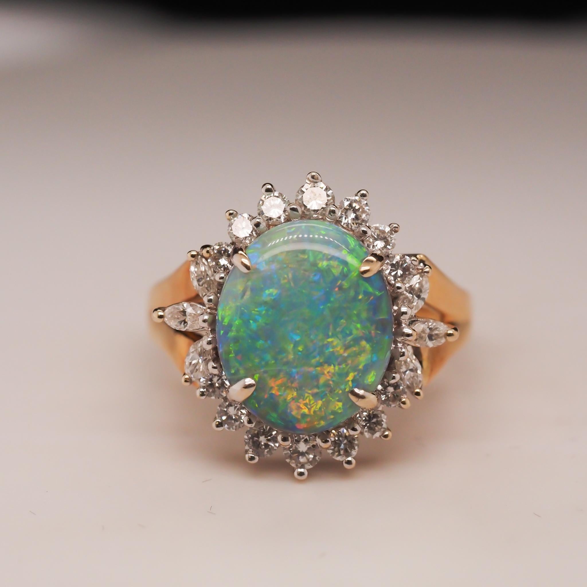 Year: 1990s
Item Details:
Ring Size: 10 (Sizable)
Metal Type: 18K Yellow Gold [Hallmarked, and Tested]
Weight: 9.0grams
Opal Details: Australian Opal. Measures 14.1m x 11.7mm. Excellent color play with flashes of Orange, Green, Blue, Yellow and