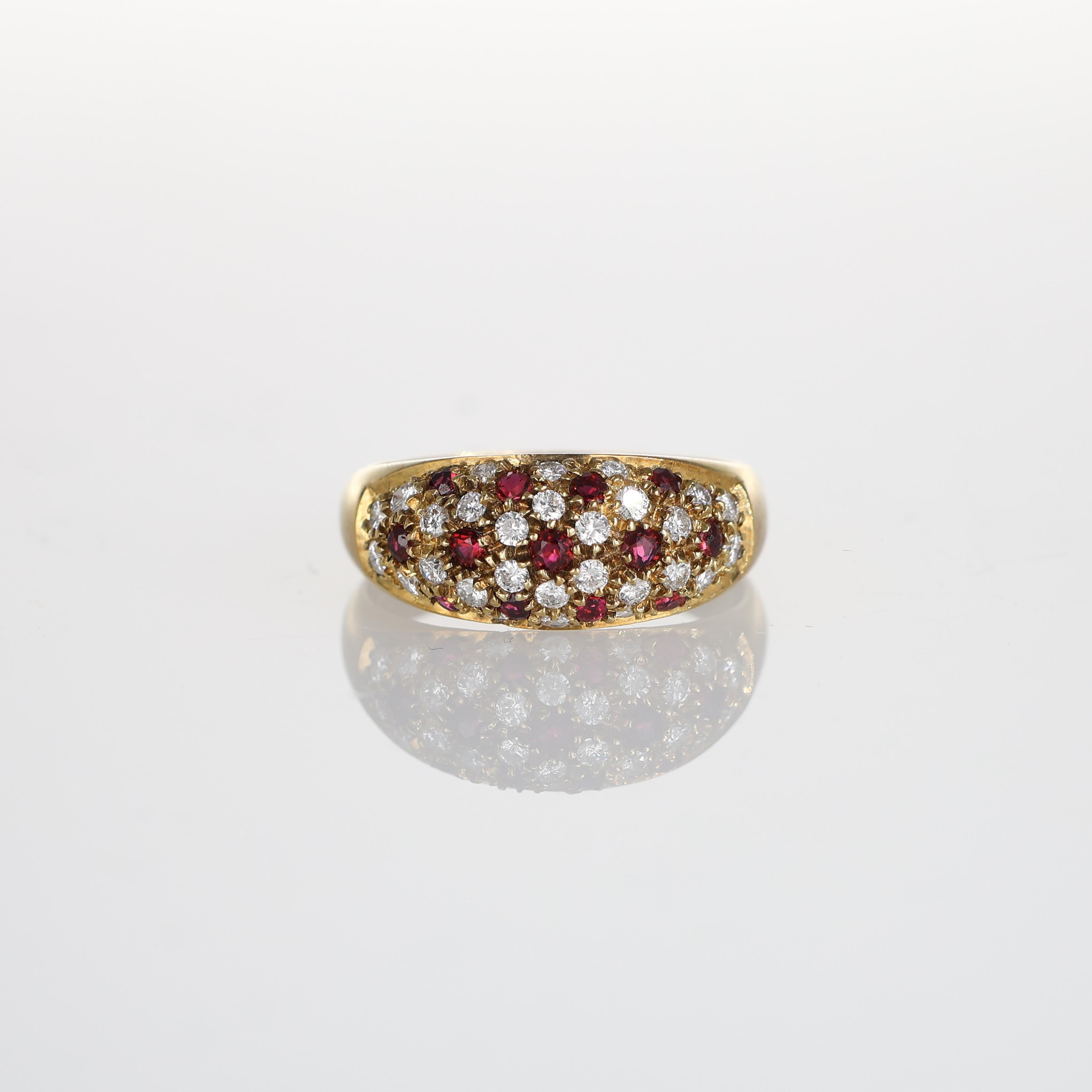 This stunning 18k yellow gold band showcases an alternating pave design of vibrant rubies and dazzling brilliant-cut diamonds. The intricate craftsmanship and luxurious materials make this piece a timeless addition to any fine jewelry collection.