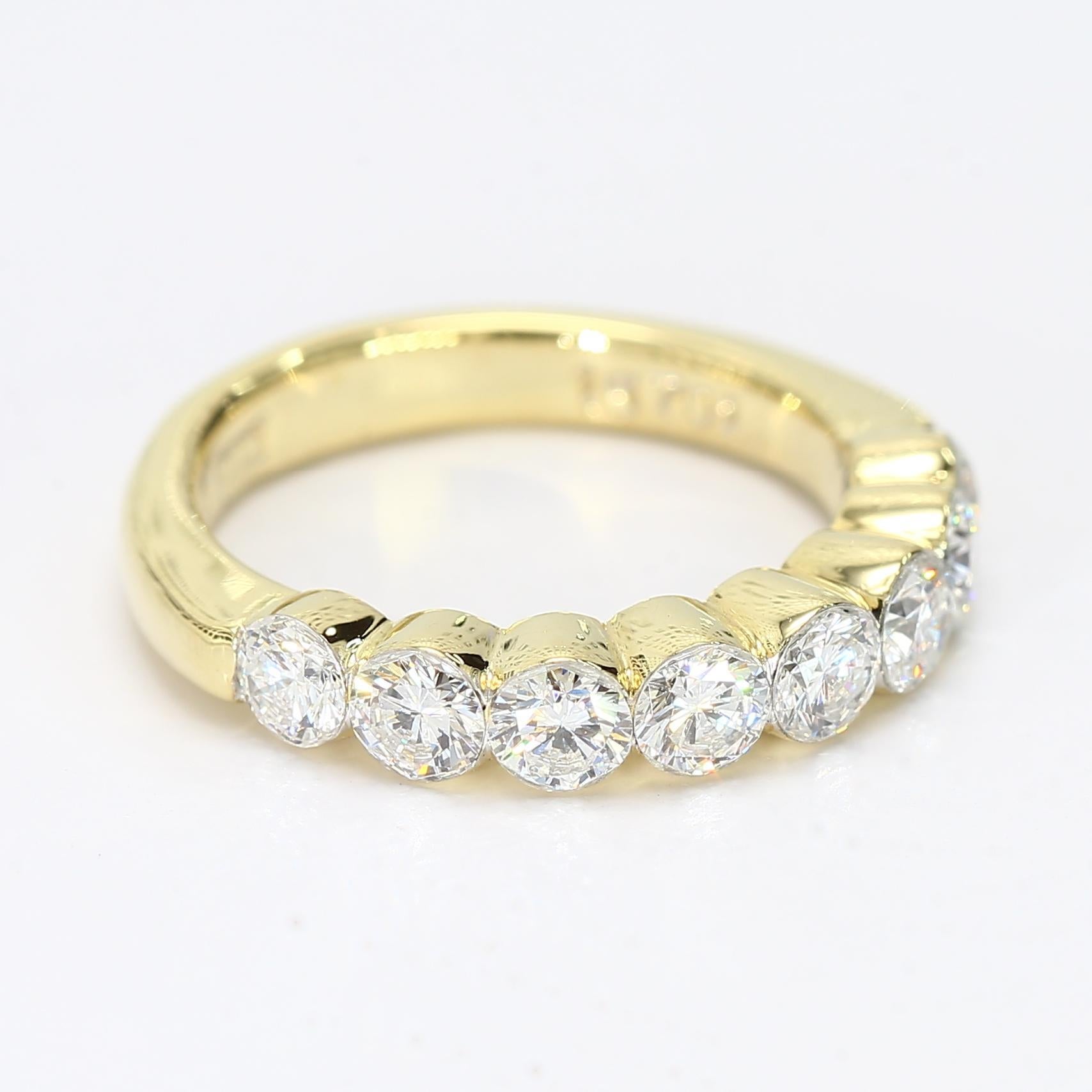 This is an 18k yellow gold band with eight bezel set diamonds each weighing ~0.17ct and is graded at VVS2/F.

- Stone Info -
8x - 3.5mm Standard Round Brilliant Diamond 0.17ct VVS2/F

Ring Size - 4
Total Weight - 4.41g
A72