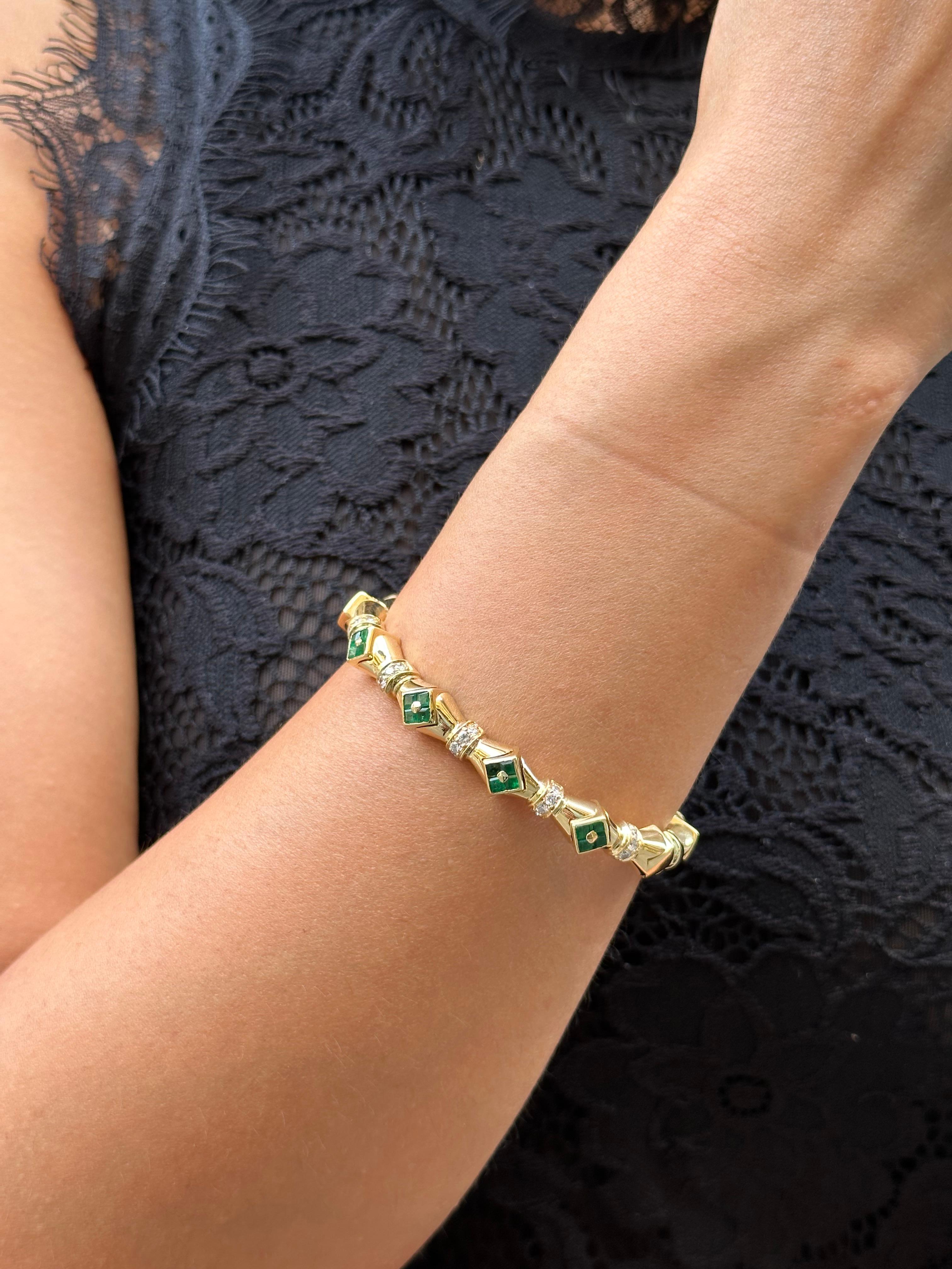 This gorgeous art-deco bangle bracelet is crafted in 45 grams 18k yellow gold , 0.60 carats diamonds and 0.40 carats emerald . 