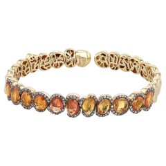 Ruwaya 18k yellow Gold bangle with orange Sapphires and Round Cut Diamonds