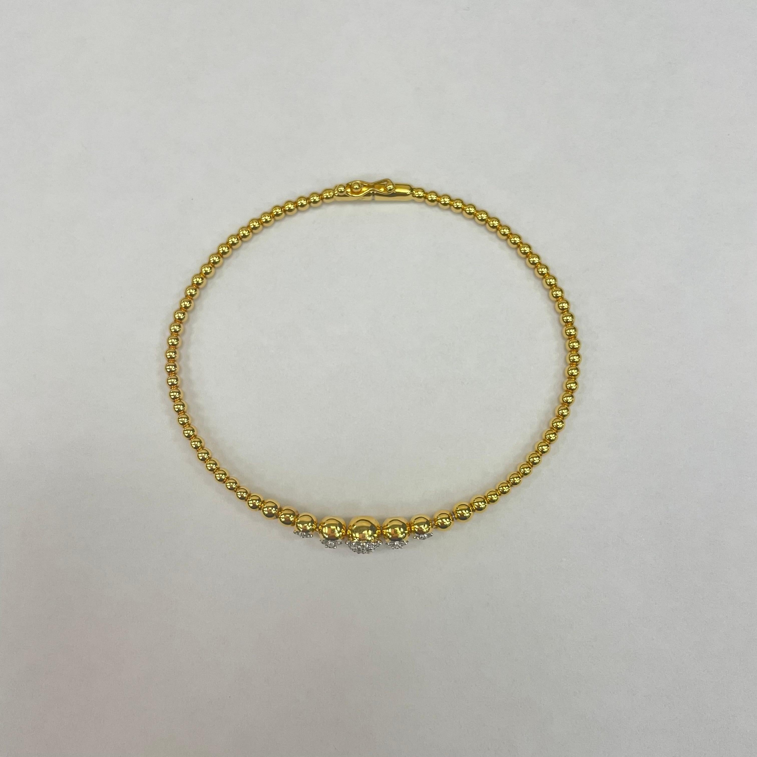 This beautiful yellow gold bangle is the perfect everyday jewellery . Featuring five pieces diamond bead, weighing 0.19 carats, totalling 39 pieces of brillant cut round diamonds. Made in 18K yellow gold.