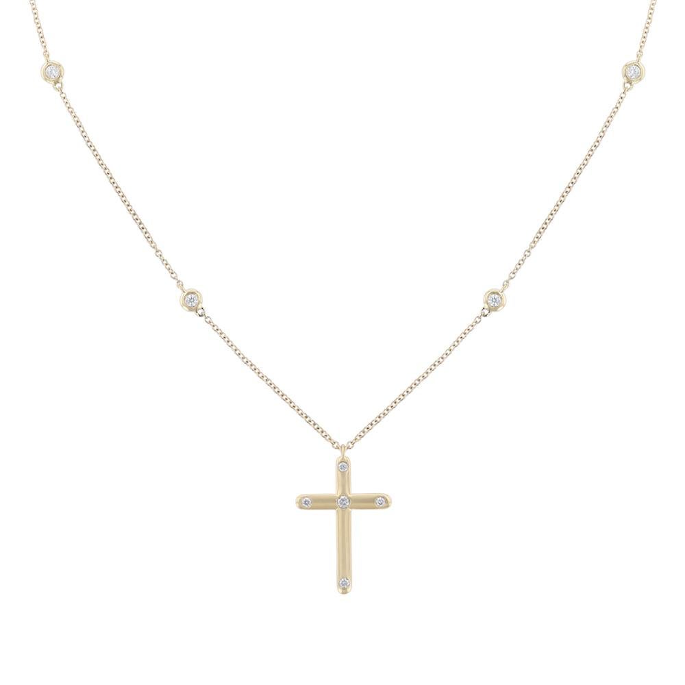 This necklace is made in 18K yellow gold and features a cross pendant with 5 round cut diamonds and 4 round cut diamonds on the chain. All diamonds are bezel set and weigh 0.20 carats combined. Necklace has a color grade (H) and clarity grade (SI1).