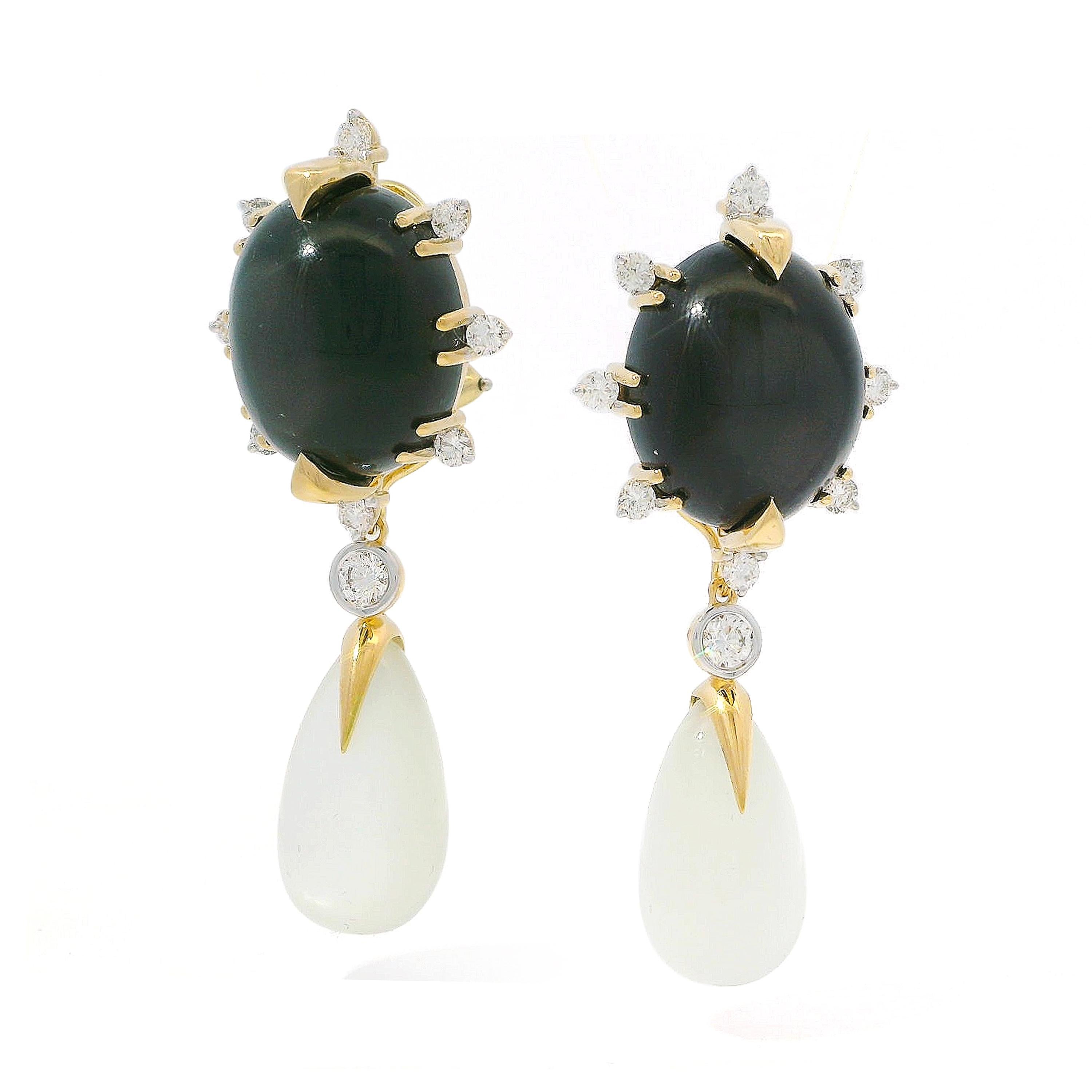 The enchanting iridescence of moonstone is displayed with diamonds in these 18k yellow gold earrings. An oval cabochon of black moonstone, emitting subtle undertones in the light, is held by gold triangular prongs. Brilliant-cut diamonds are placed