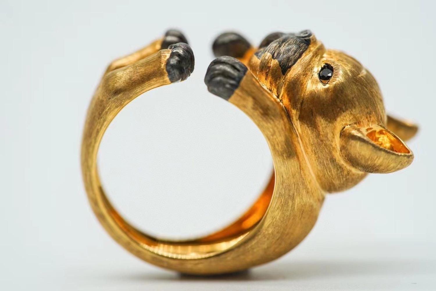 18K Yellow Gold Black Diamond Dog Ring

Black Diamonds - 0.07 CT
18K Gold - 10.06 GM

Jewelry Designer Brand from Hong Kong.

Meticulously crafted with exceptional artistry, this delightful ring captures the playful spirit of your pet in stunning